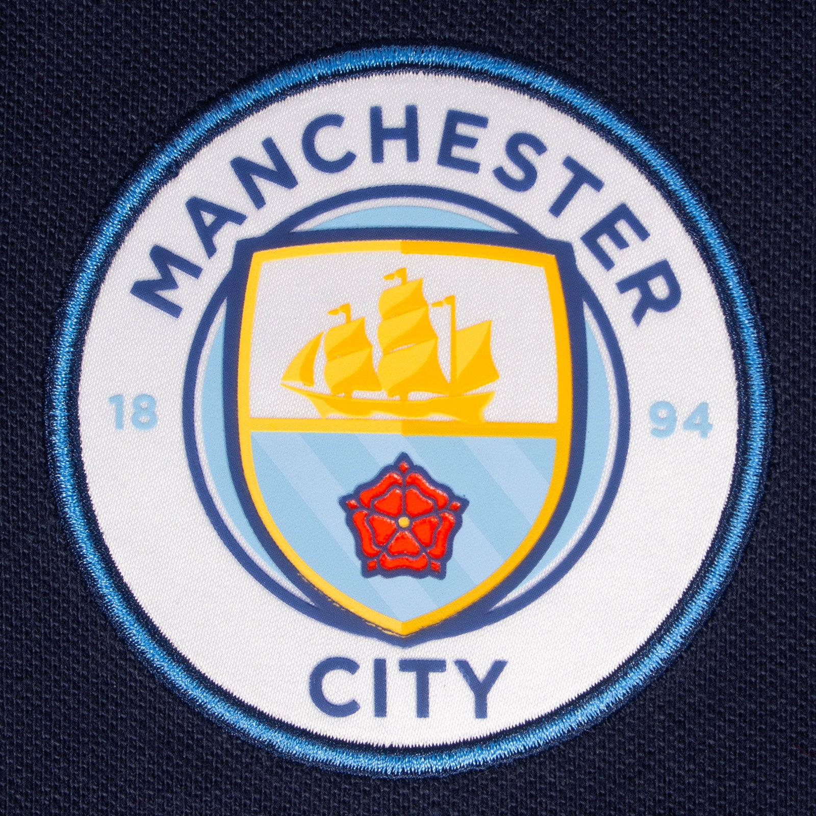 Man City adults polo shirt in navy blue with club crest to the chest.