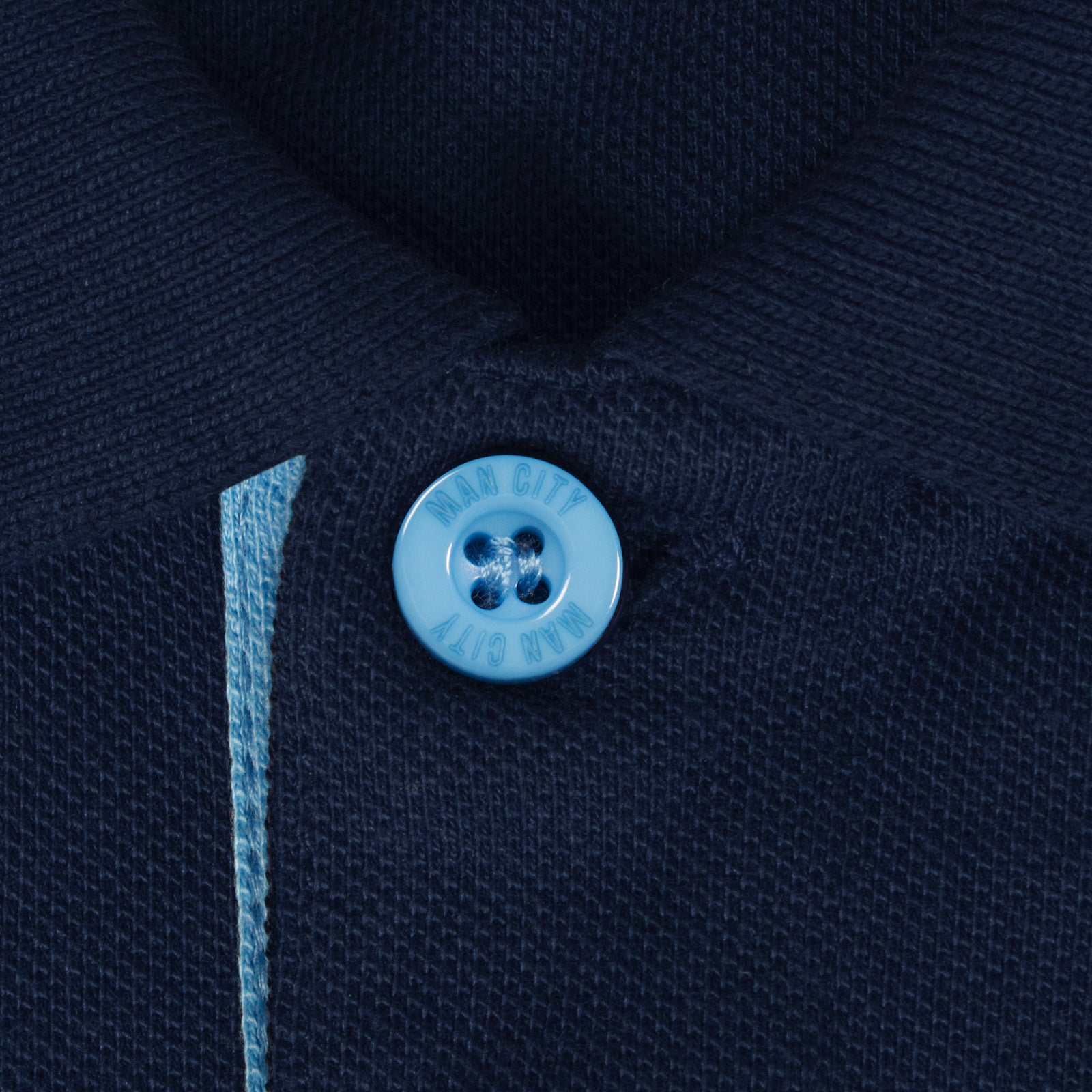 Man City adults polo shirt in navy blue with contrast sleeve and club crest to the chest.