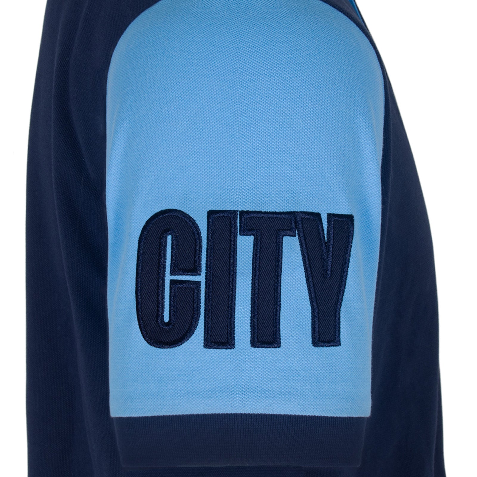 Man City adults polo shirt in navy blue with contrast sleeve and club crest to the chest.
