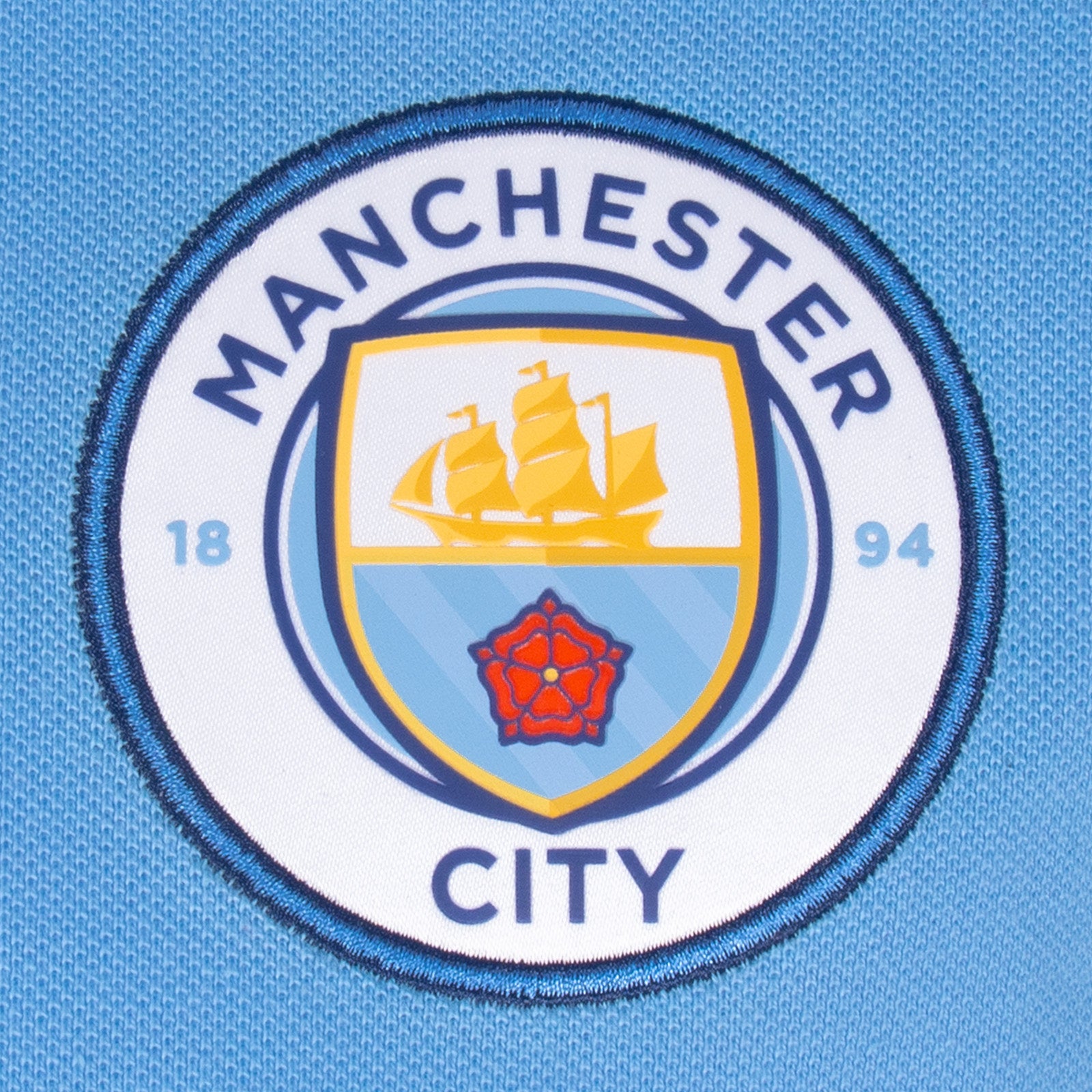 Man City adults polo shirt in sky blue with club crest to the chest.