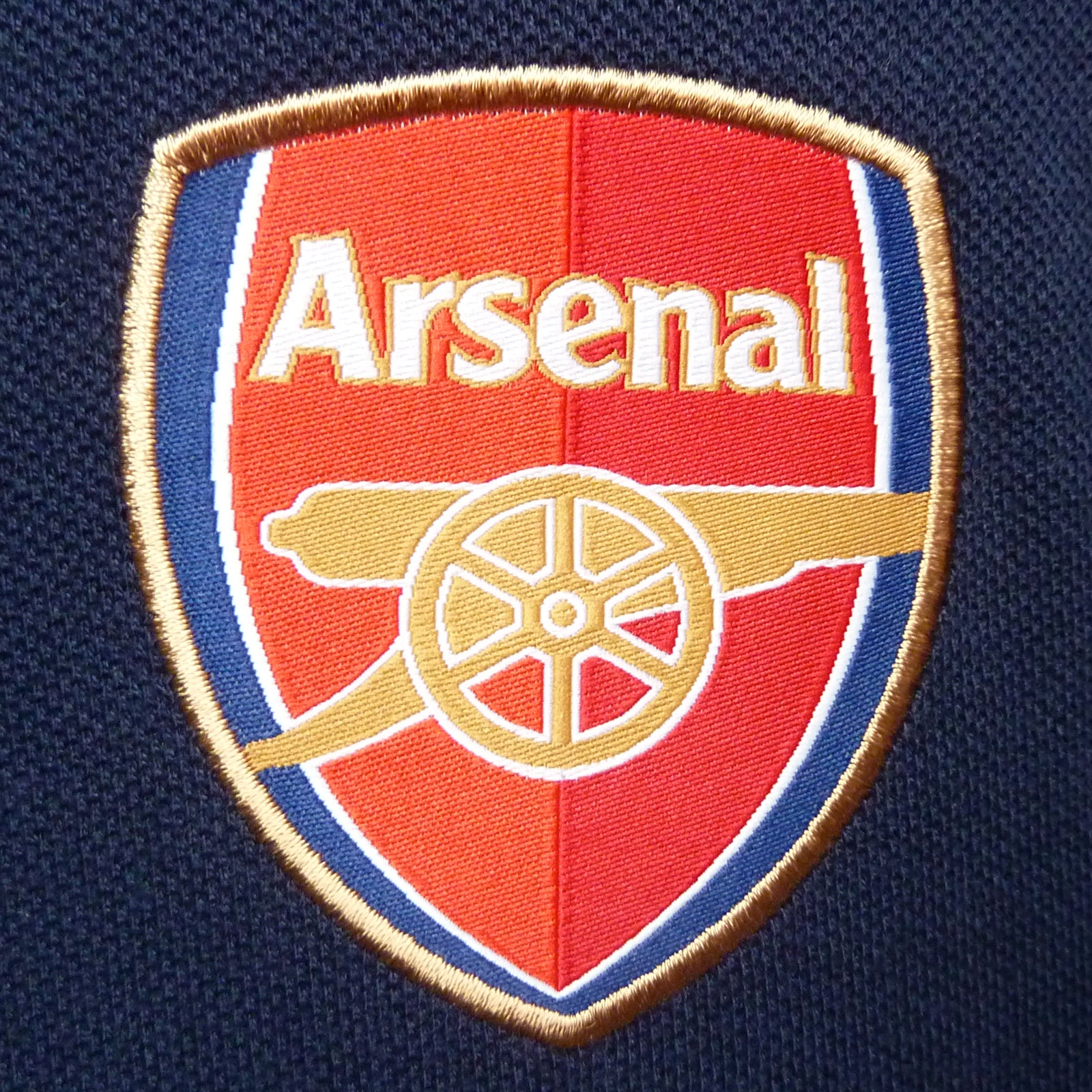 Arsenal polo shirt for kids in navy blue with club crest and canon to chest.