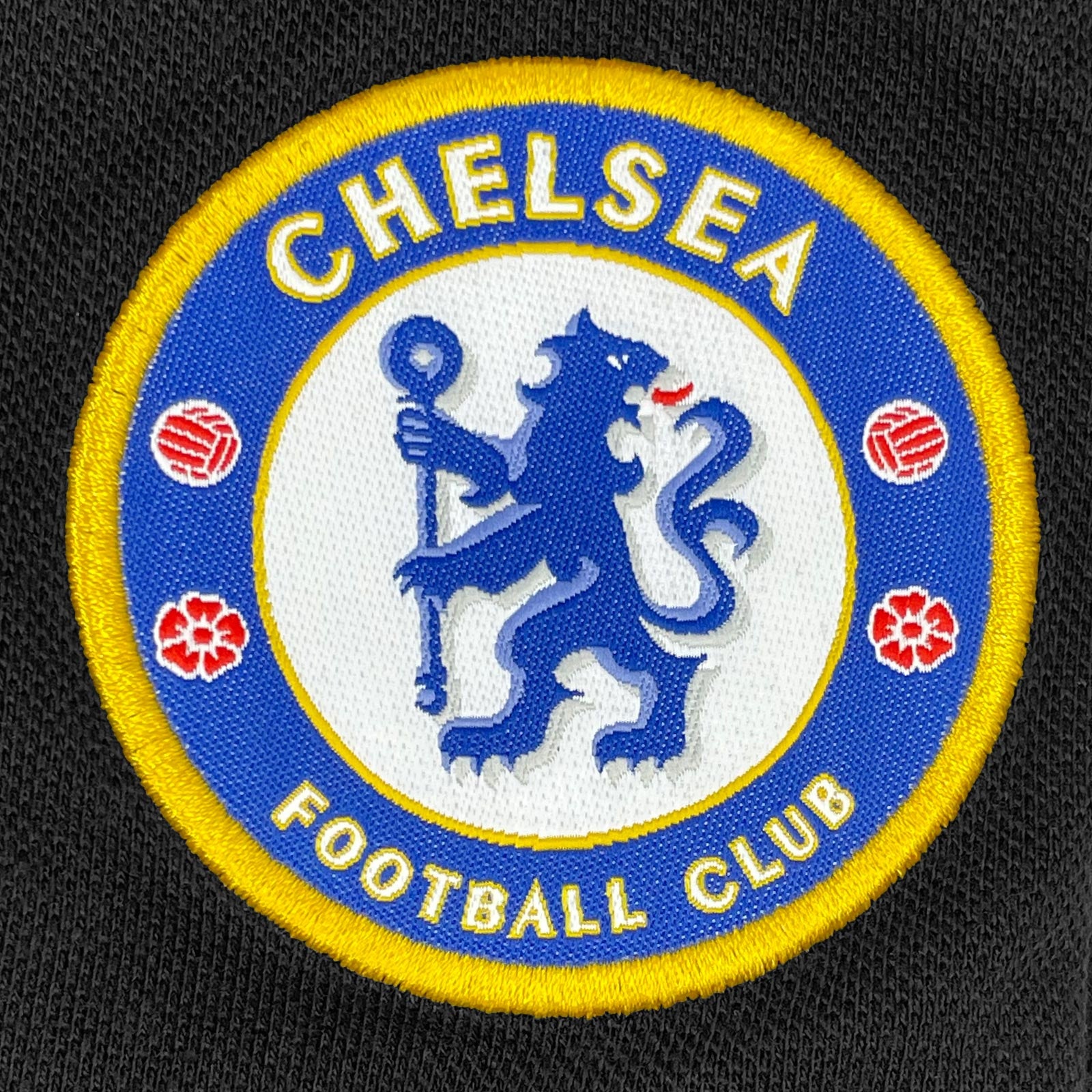Chelsea adults polo shirt in black with crest and Chelsea FC text to chest