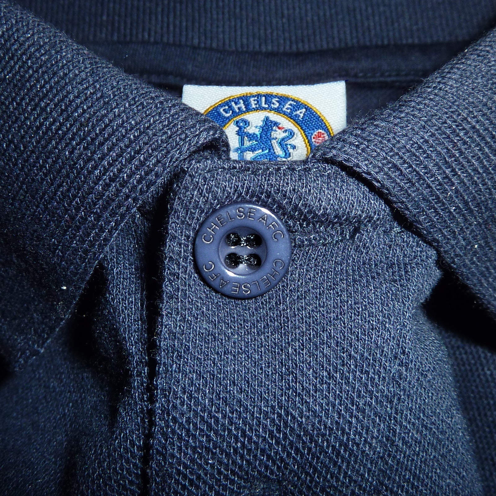 Chelsea adults polo shirt in navy with crest and Chelsea FC text to chest