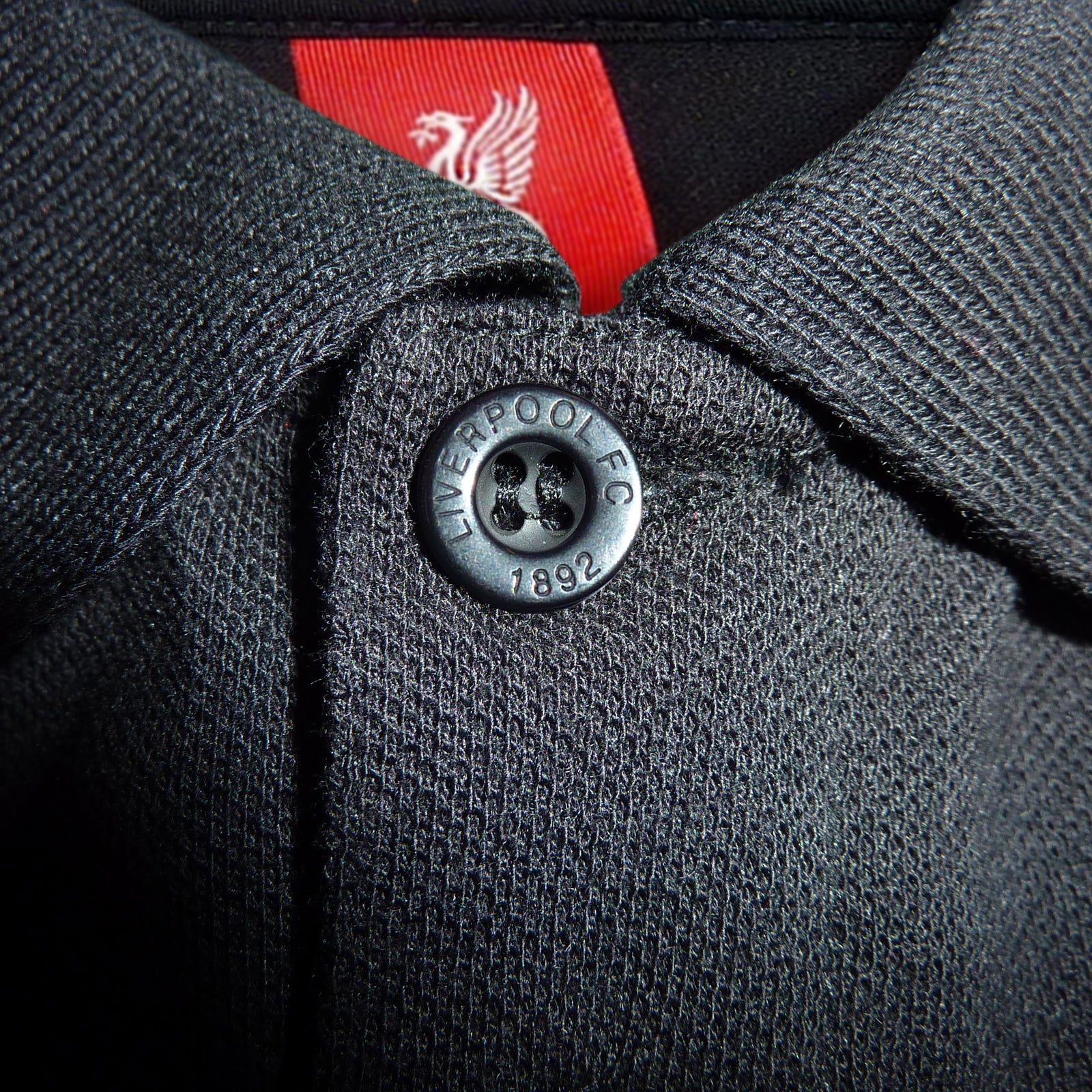 Liverpool adults polo shirt in black & contrast sleeve with LFC badge and Liverpool FC text to chest.