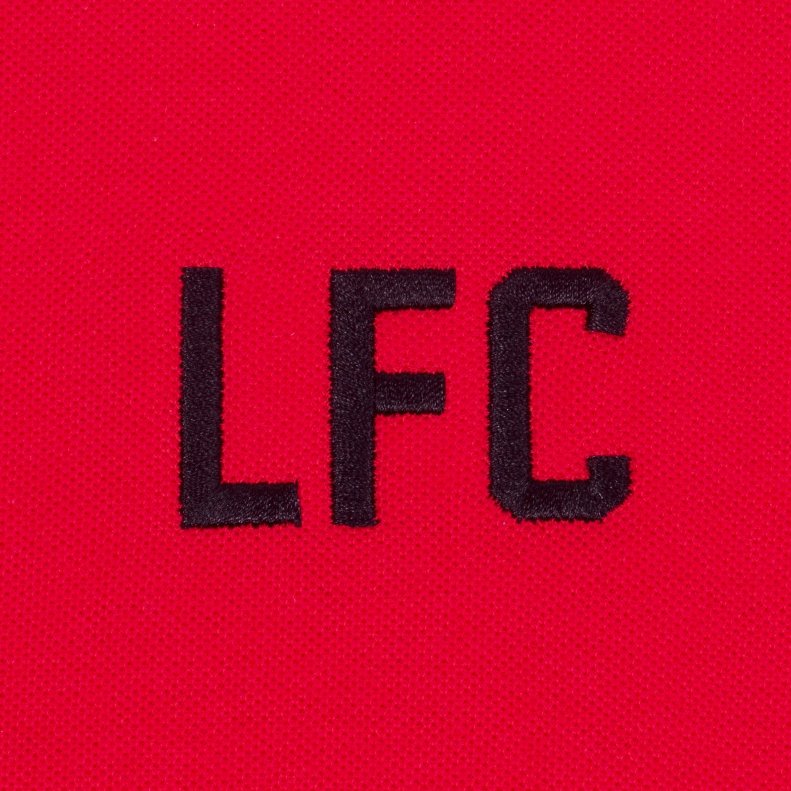Liverpool kids polo shirt in red with LFC badge and Liverpool FC text to chest.