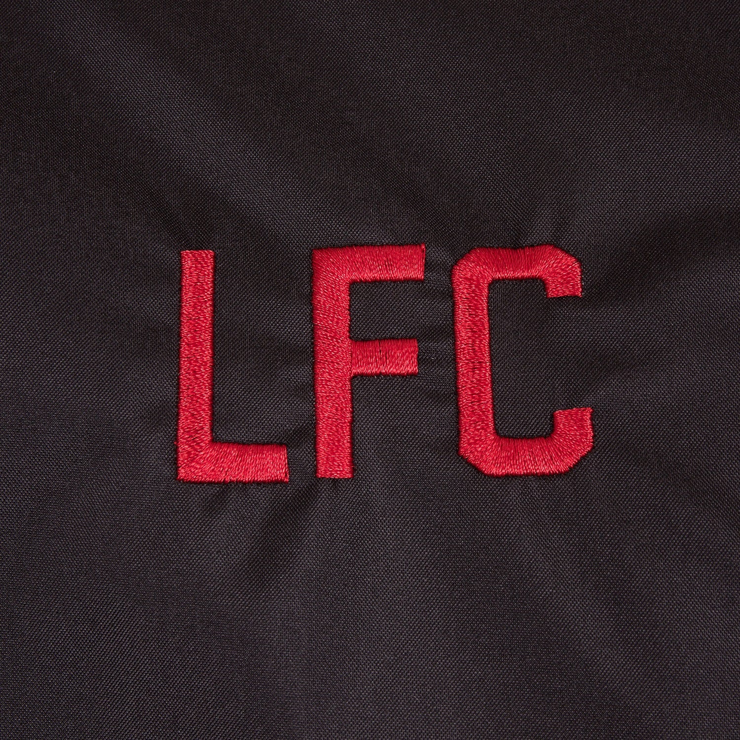 Liverpool adults shower jacket with hood in black with club crest to chest.