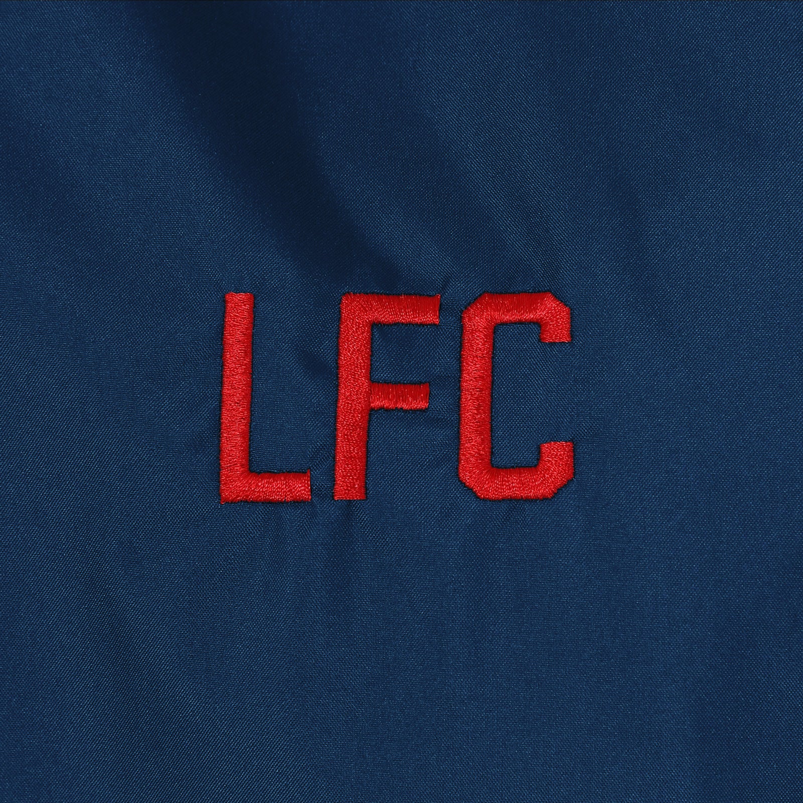 Liverpool adults shower jacket with hood in navy with club crest to chest.