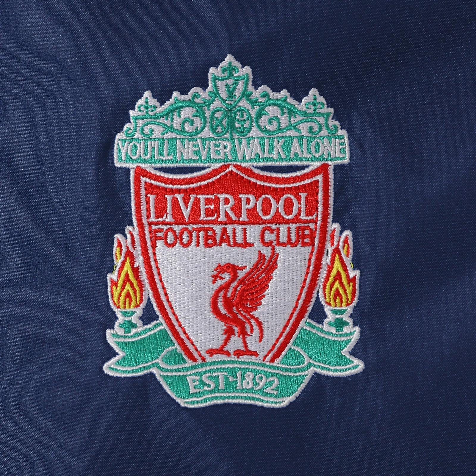 Liverpool adults shower jacket with hood in navy with club crest to chest.