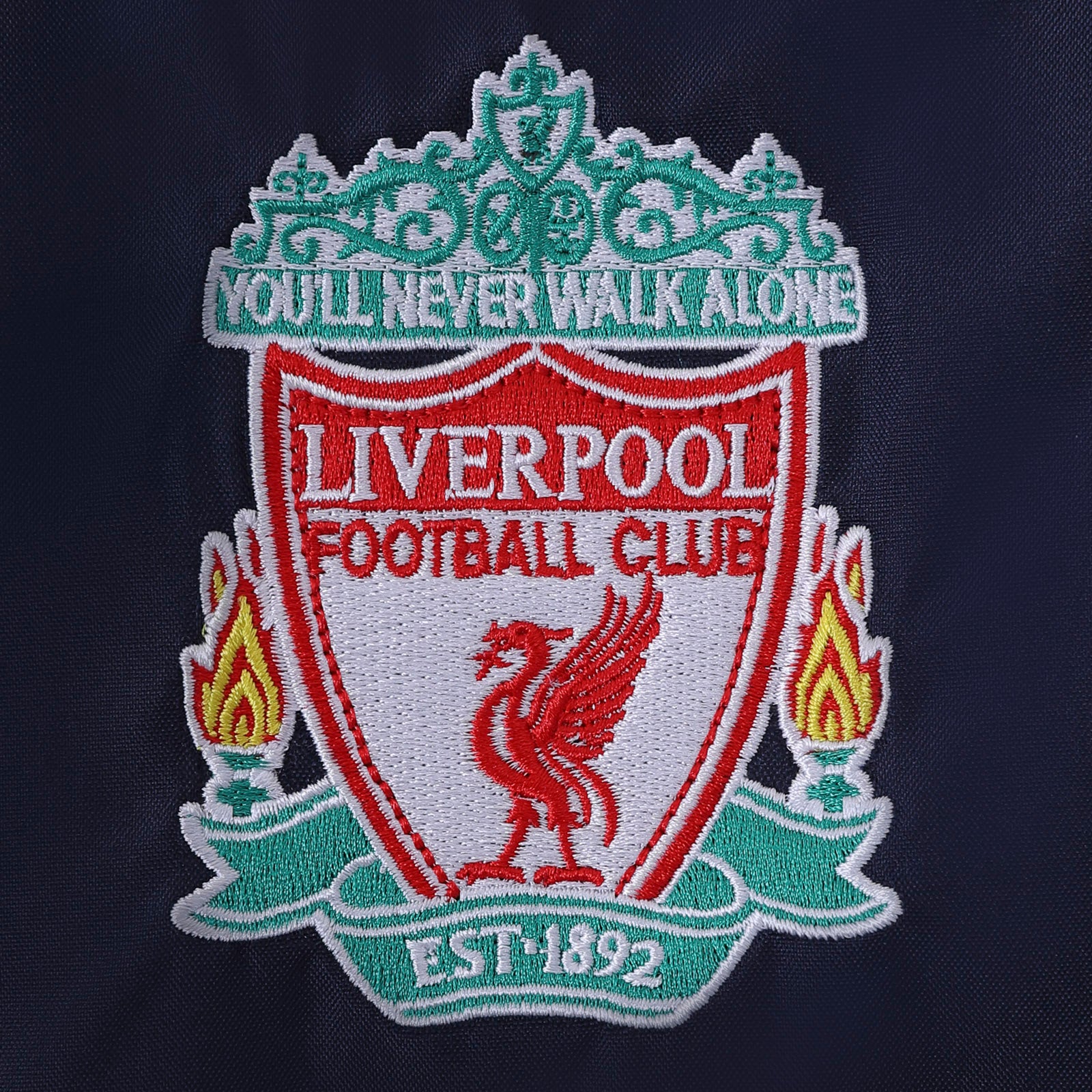 Liverpool kids shower jacket with hood in navy blue with club crest to chest.