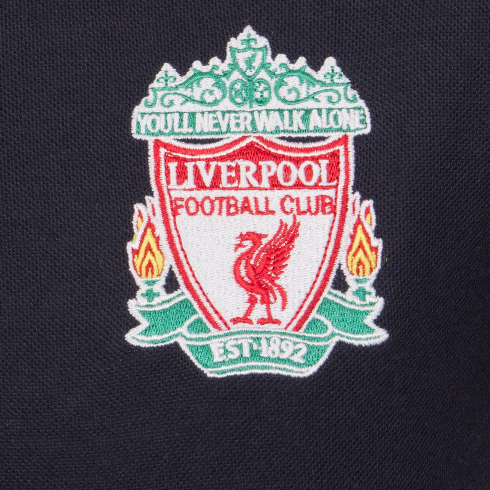 Liverpool kids polo shirt in black with LFC badge and Liverpool FC text to chest.