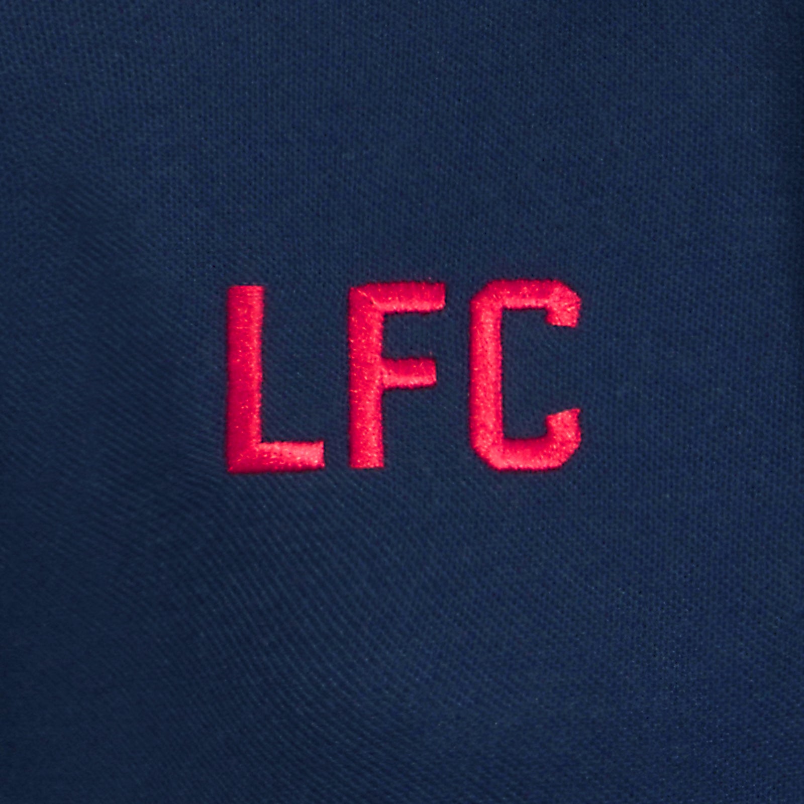 Liverpool kids polo shirt in navy blue with LFC badge and Liverpool FC text to chest.