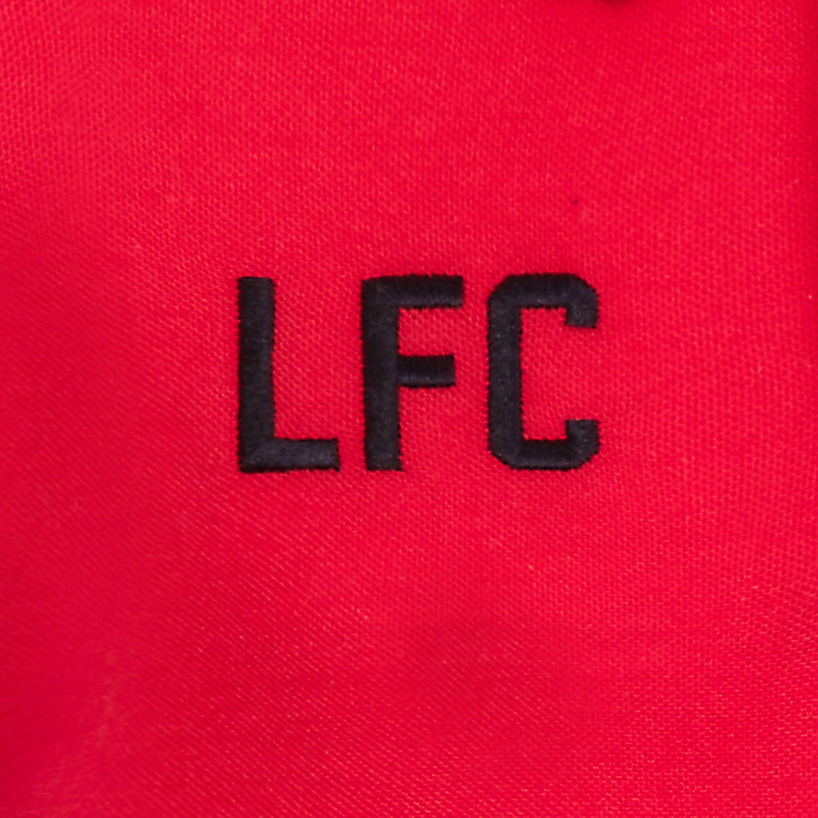 Liverpool adults polo shirt in red with LFC badge and Liverpool FC text to chest.