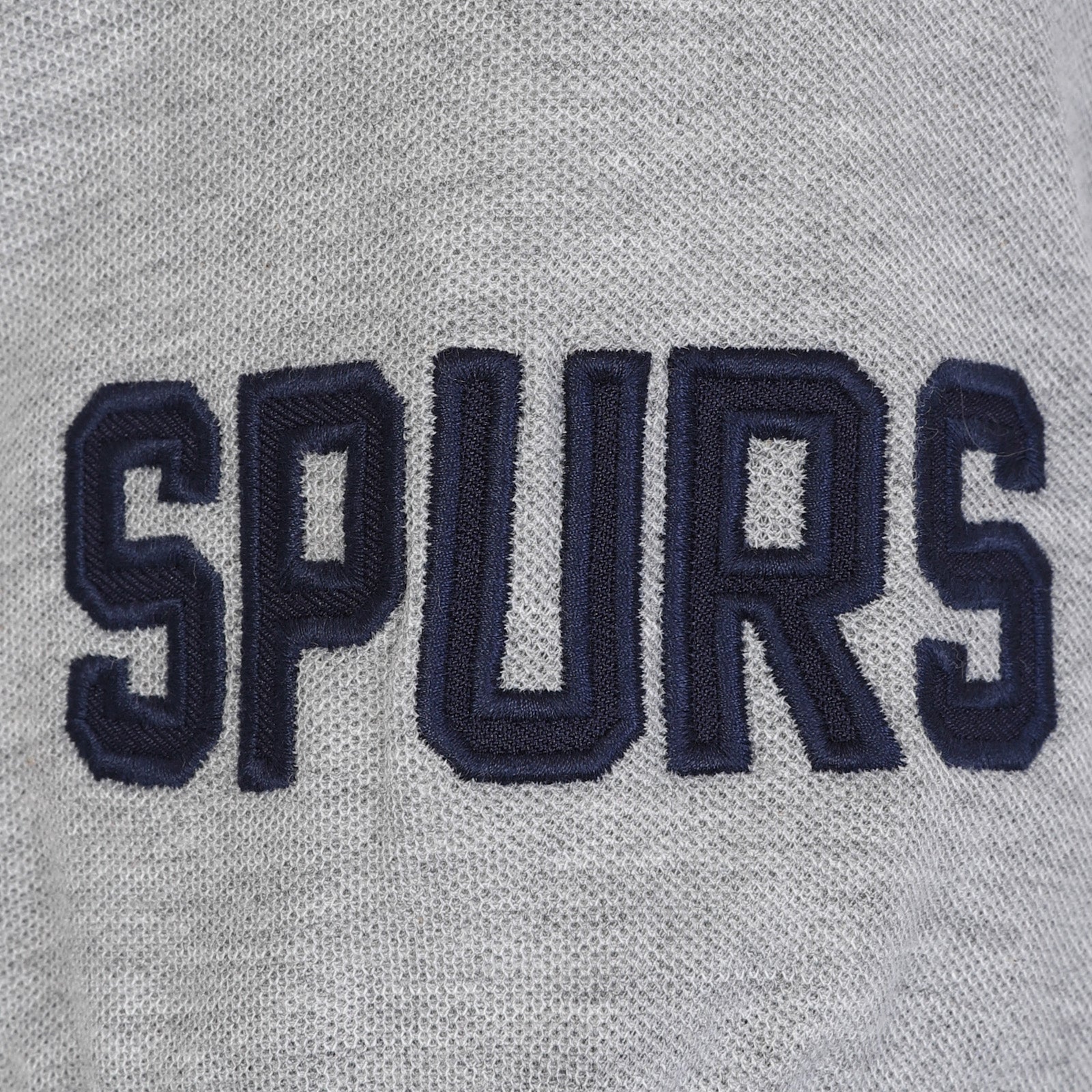 Spurs adults polo shirt in navy blue with contrast sleeve and Spurs badge and text to chest.