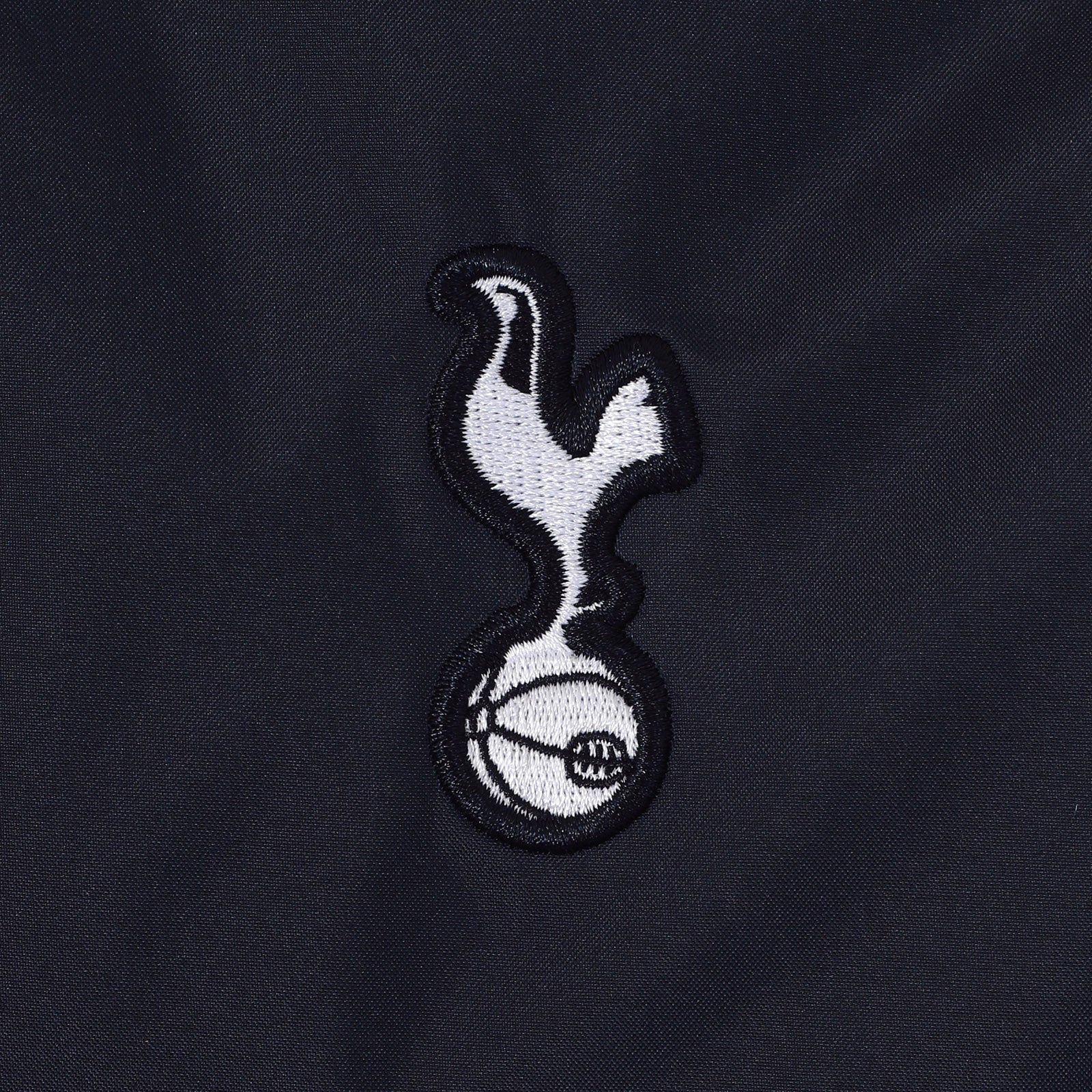 Spurs adults hooded shower jacket in navy with club crest to the chest.