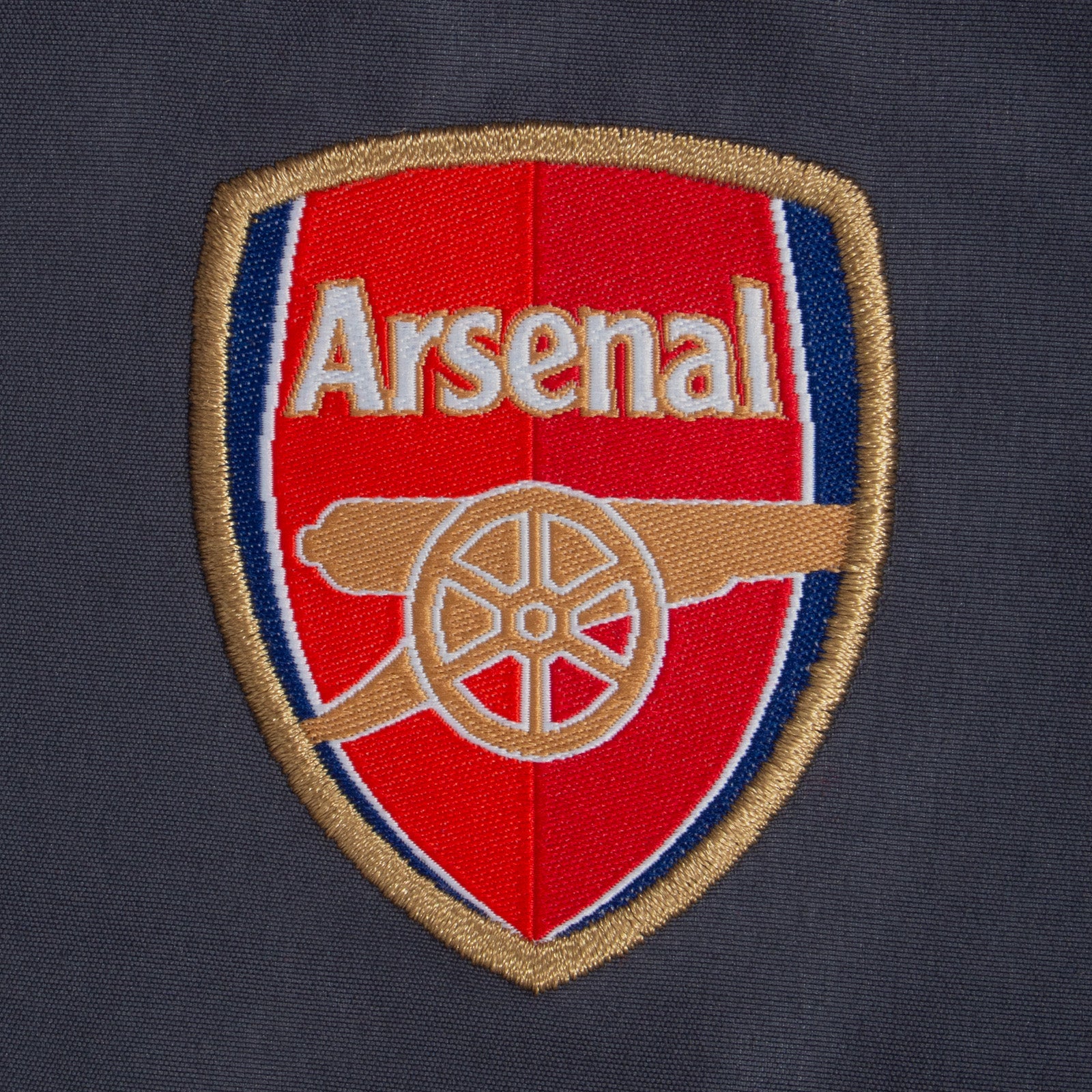 Arsenal kids tracksuit in black with club crest to chest and left thigh