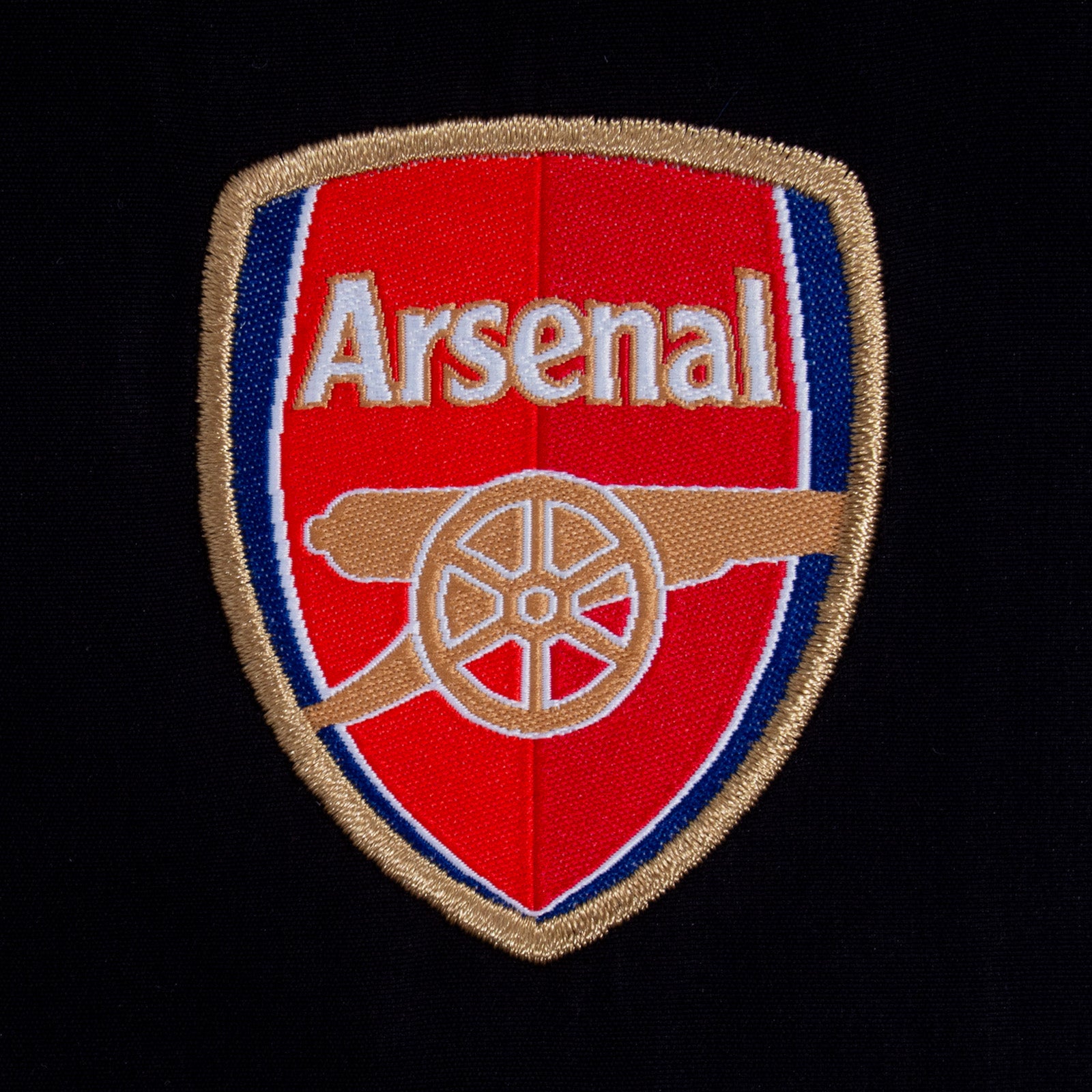 Arsenal kids tracksuit in black with club crest to chest and left thigh