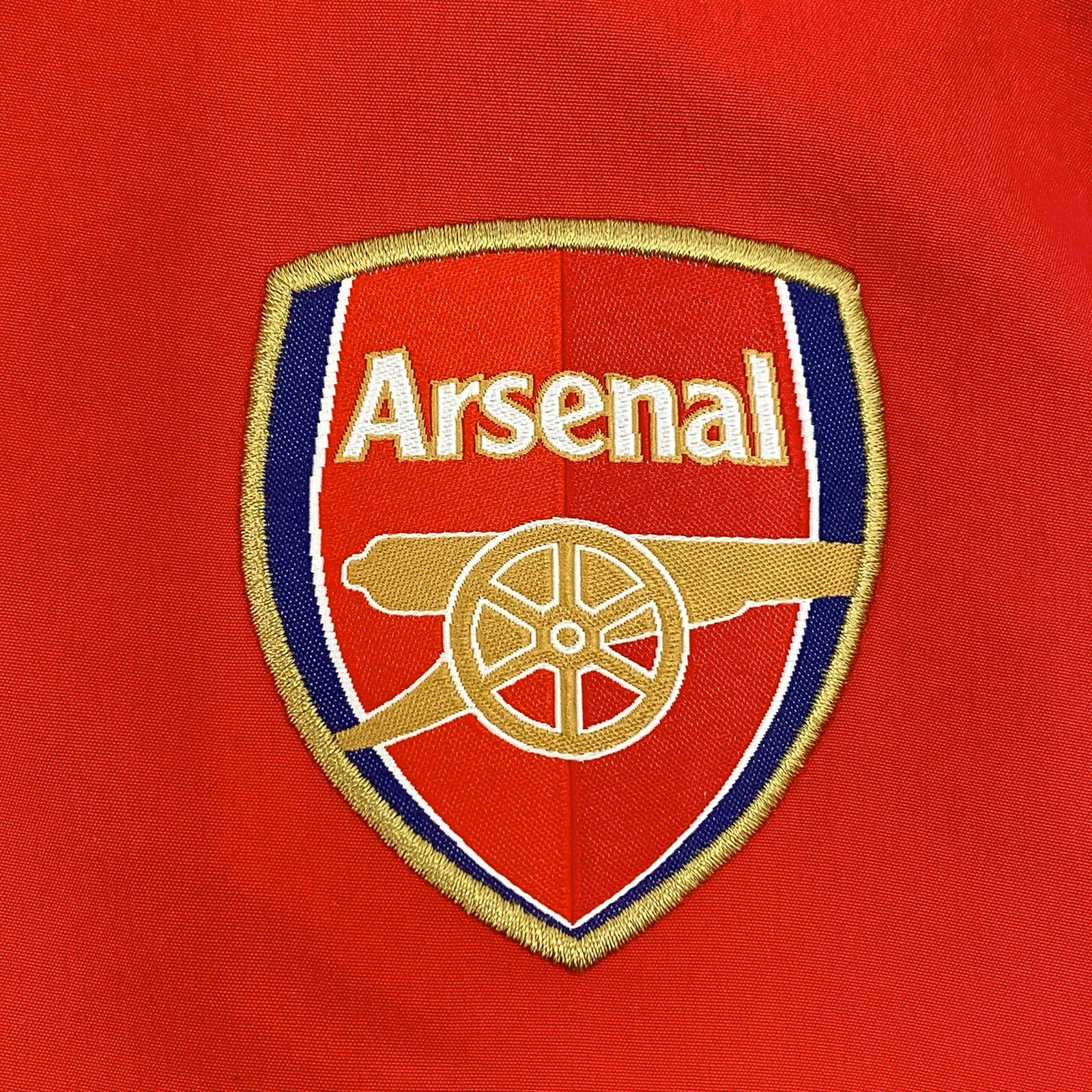Arsenal adults tracksuit in navy blue & red with club crest to chest and left thigh