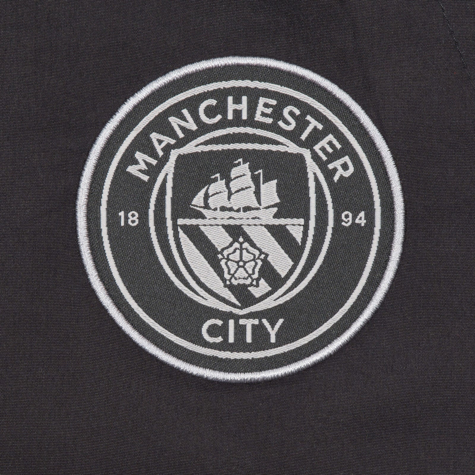 Man City adults tracksuit in grey with club crest to chest and left thigh