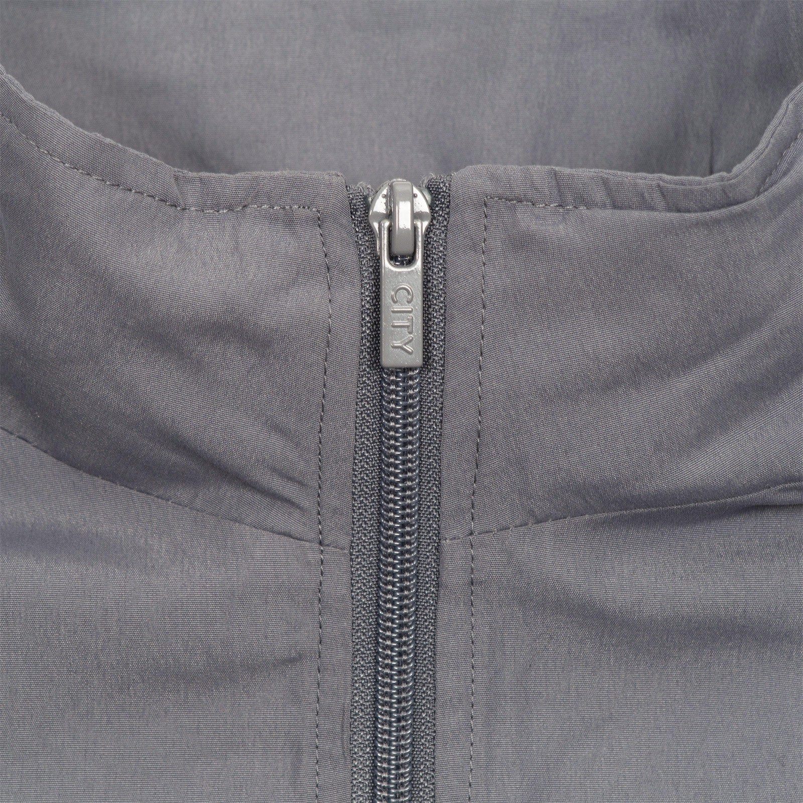 Man City adults tracksuit in grey with club crest to chest and left thigh