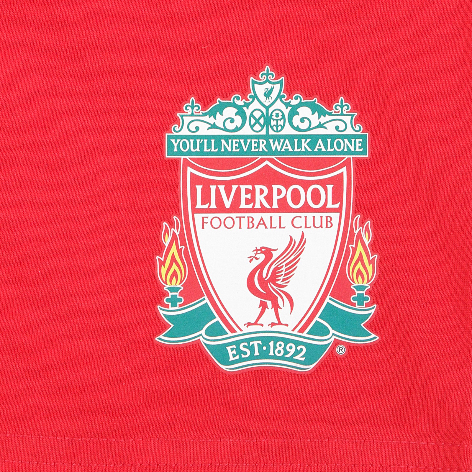 Liverpool kids pyjamas in red. Short sleeve top with graphic and shorts with logo to the left leg