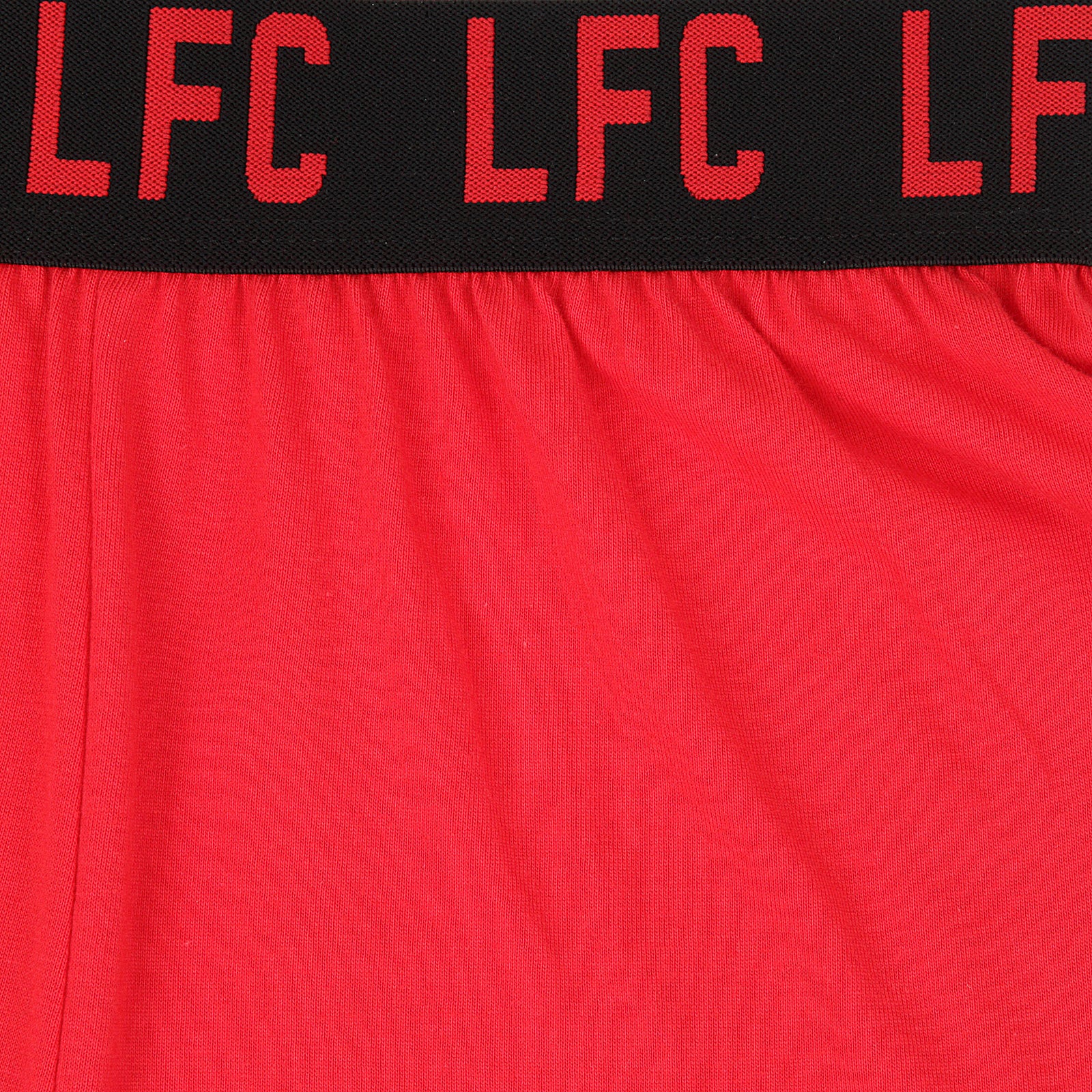 Liverpool kids pyjamas in red. Short sleeve top with graphic and shorts with logo to the left leg