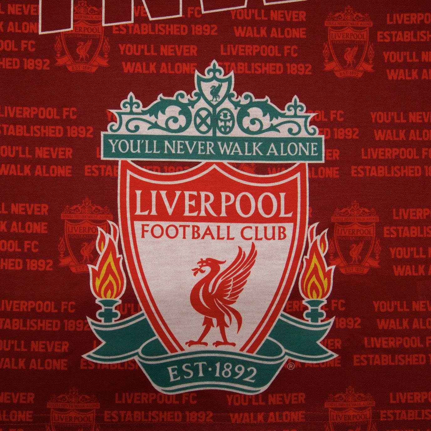 Liverpool kids pyjamas in red. Short sleeve top with graphic and shorts with logo to the left leg
