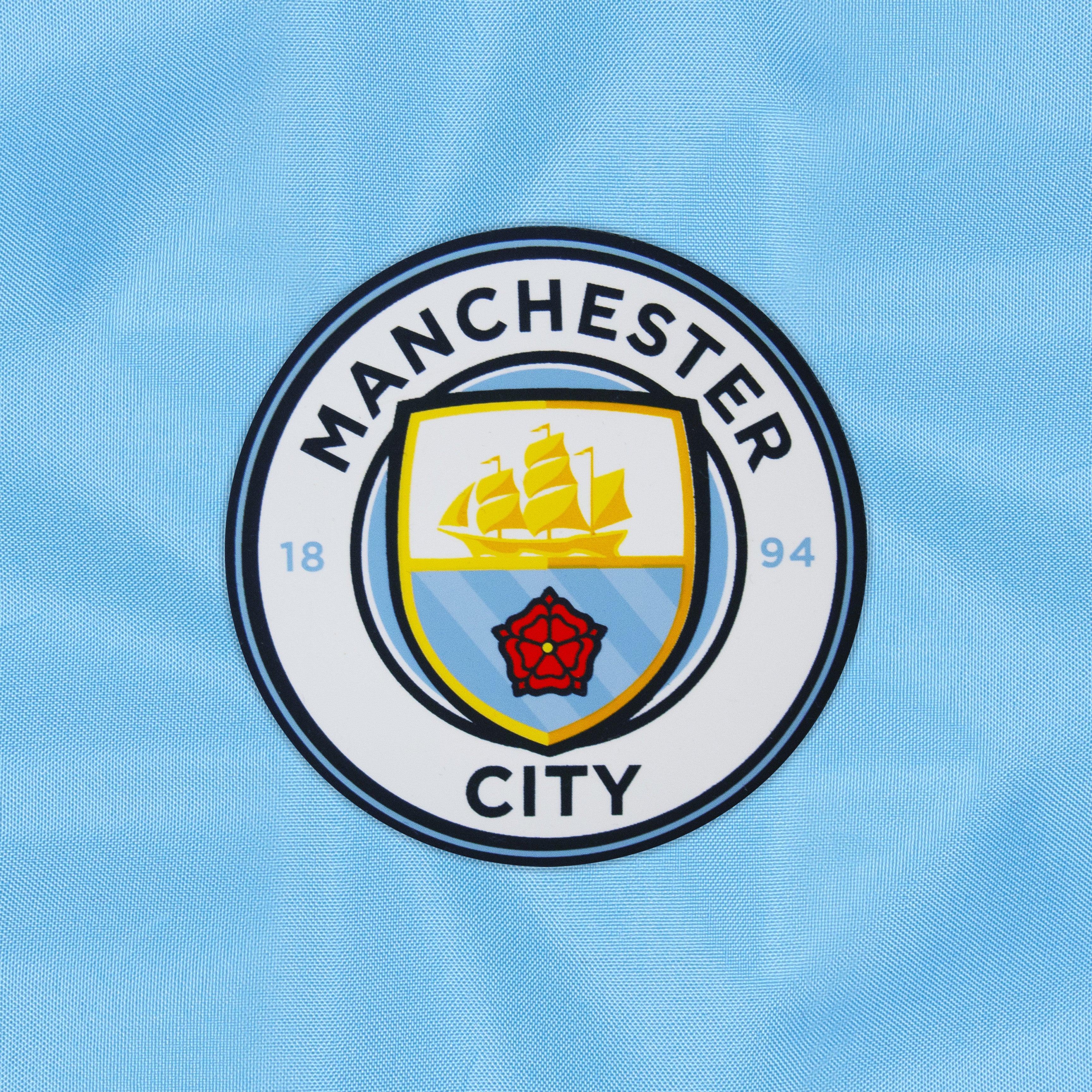 Man City adults shower jacket in navy & sky blue with club crest to chest.