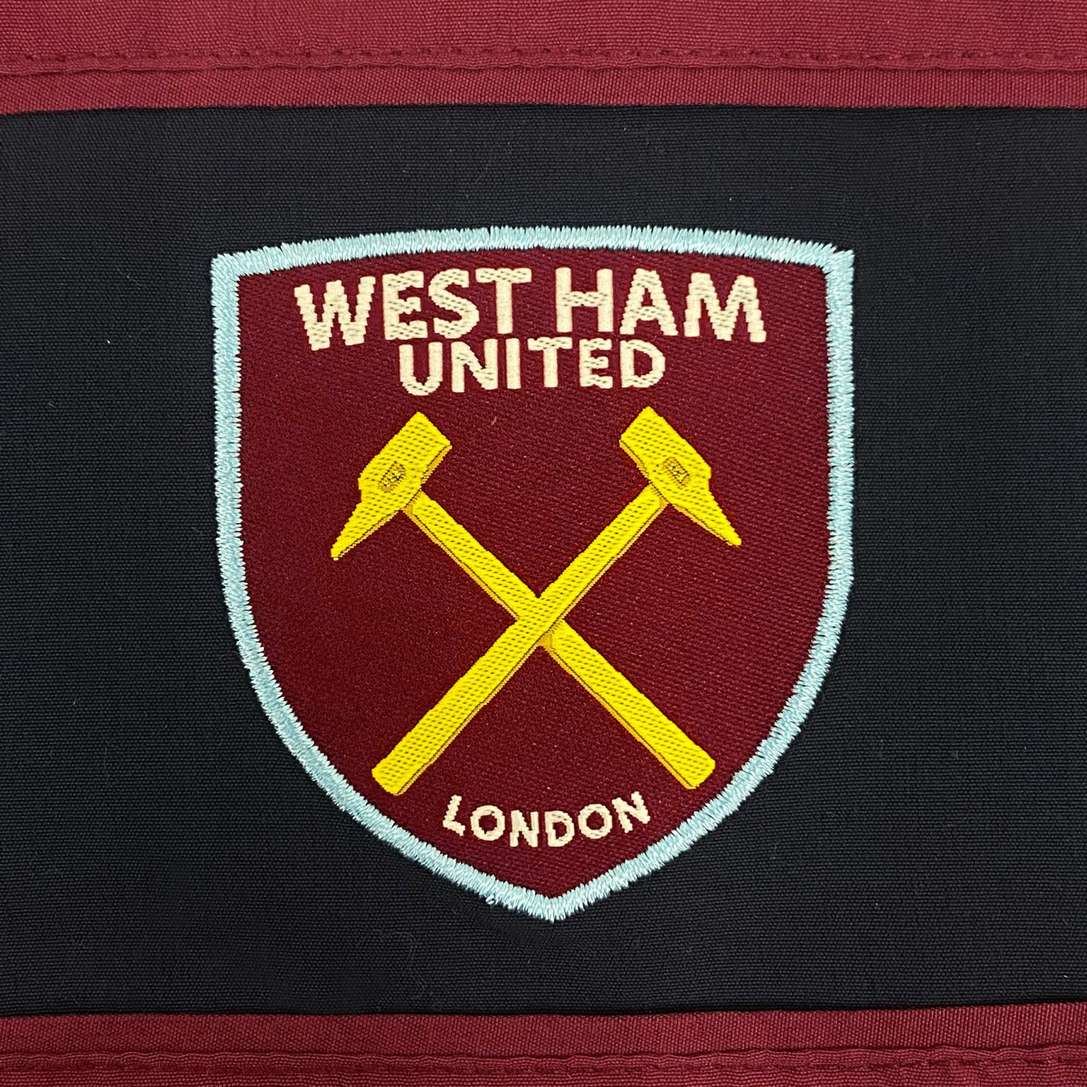 West Ham kids tracksuit in navy blue & claret with club crest to chest and left thigh