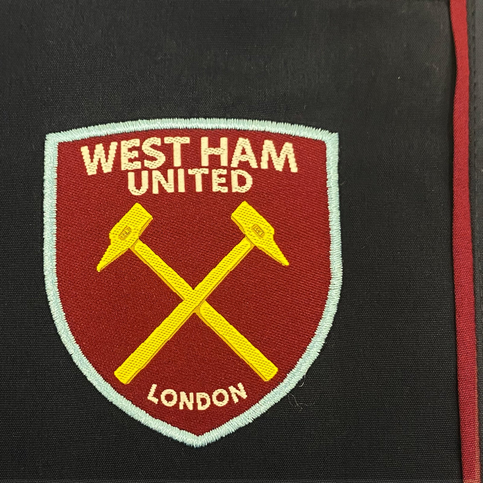West Ham kids tracksuit in navy blue & claret with club crest to chest and left thigh