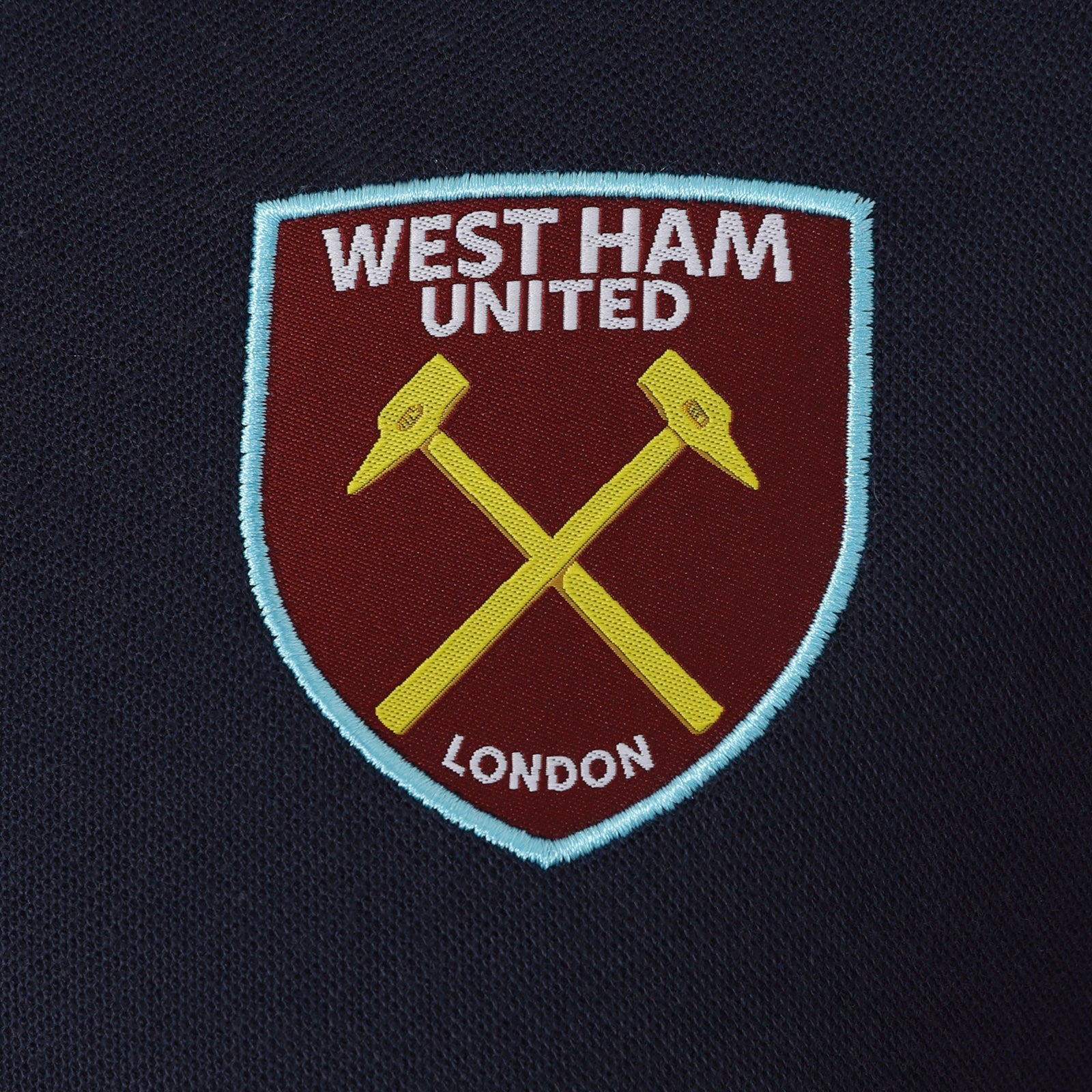 West Ham kids polo shirt in claret with WHUFC badge and text to chest.