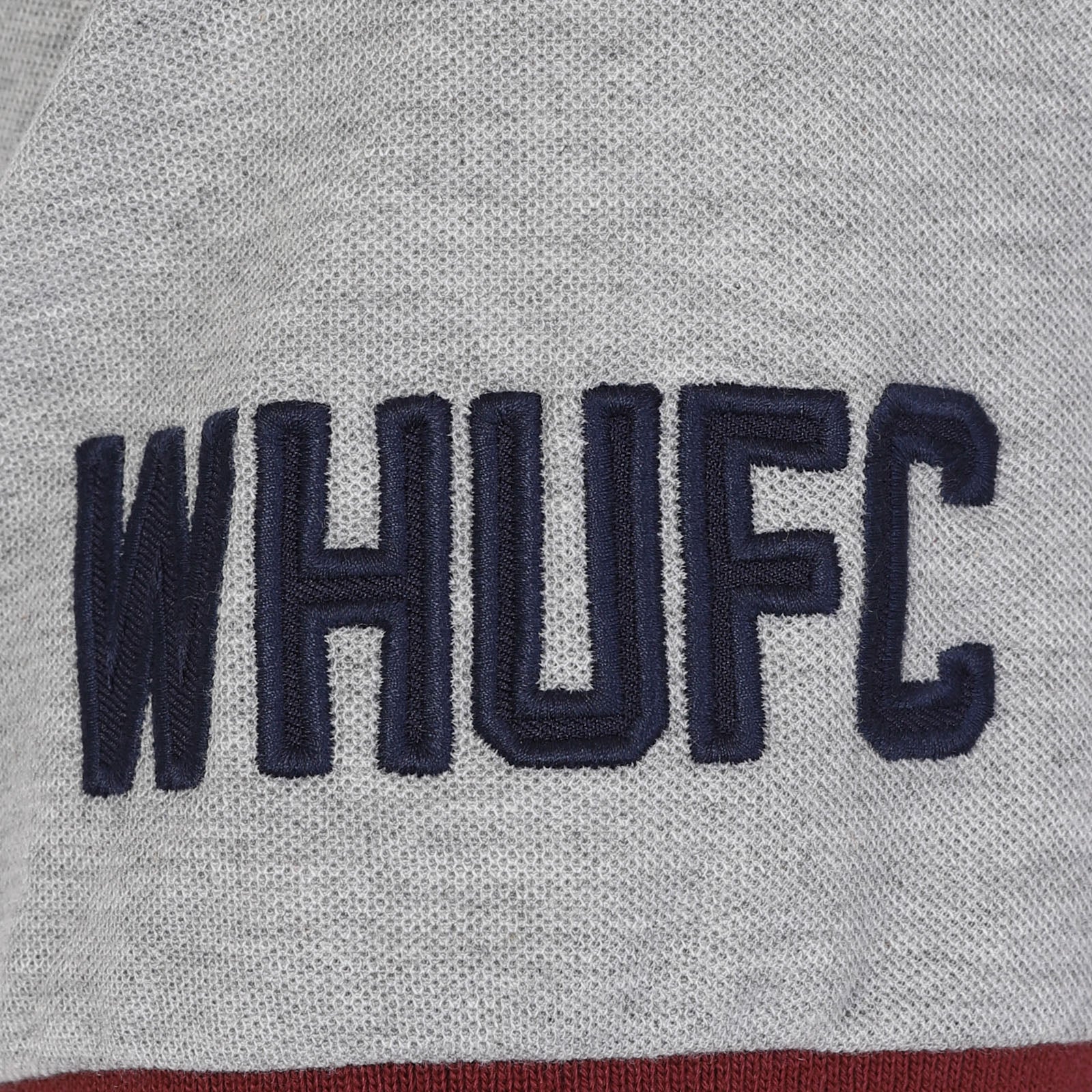 West Ham kids polo shirt in claret with WHUFC badge and text to chest.