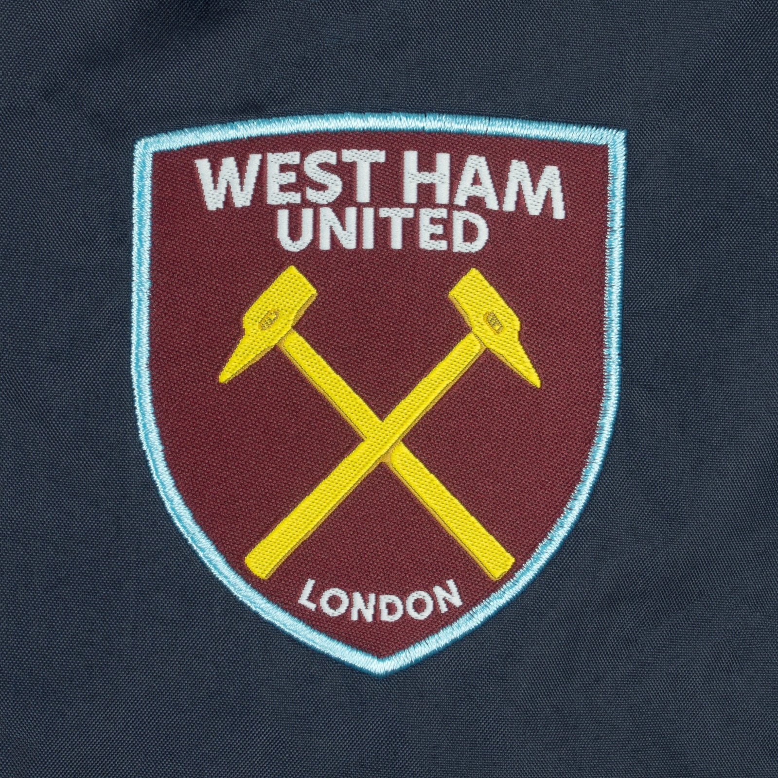 West Ham adults shower jacket in navy with club crest and pockets to front