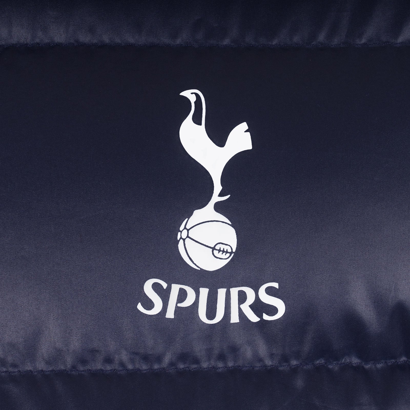 Spurs kids quilted jacket in navy blue with club crest to chest.