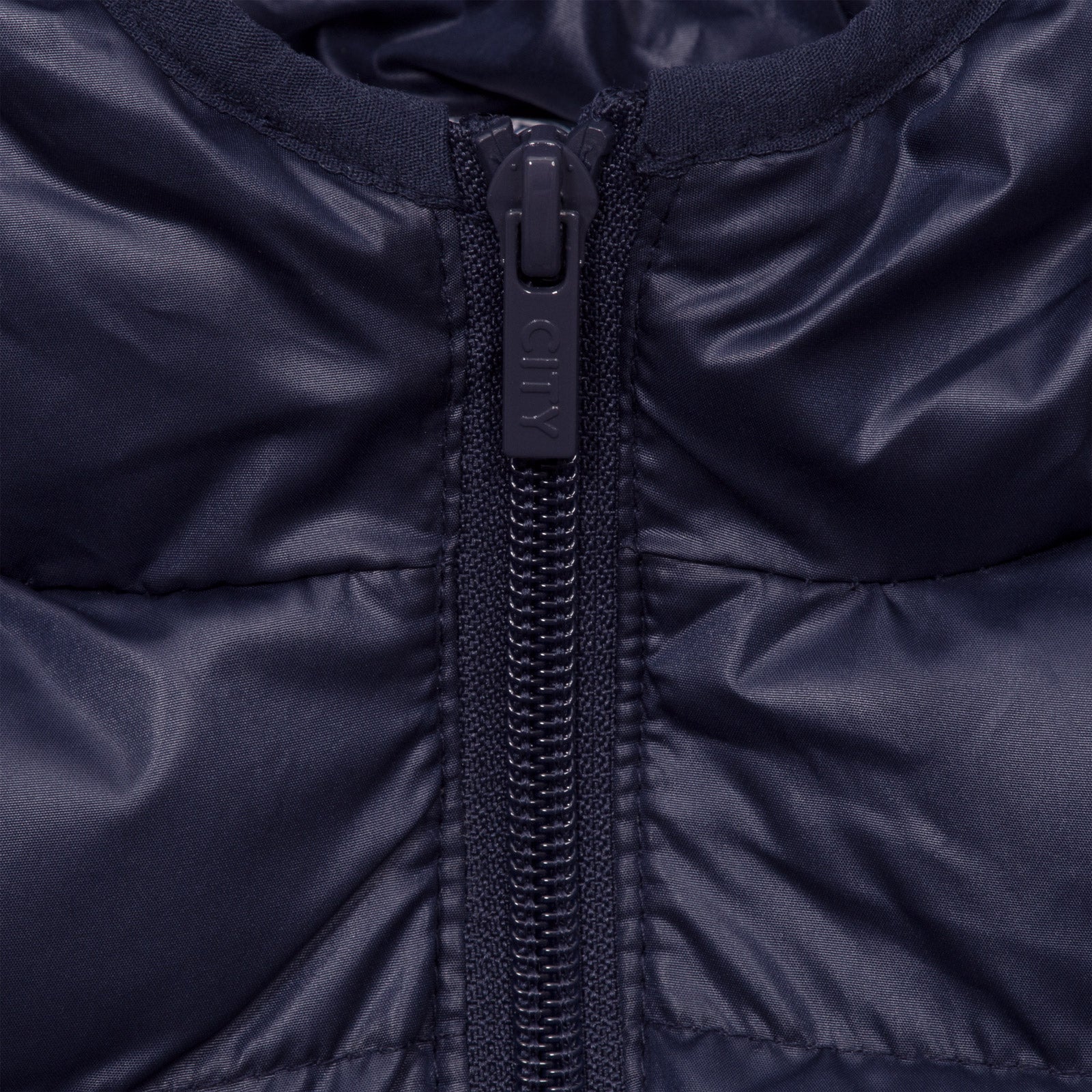 Man City kids quilted jacket in navy blue with club crest to chest.