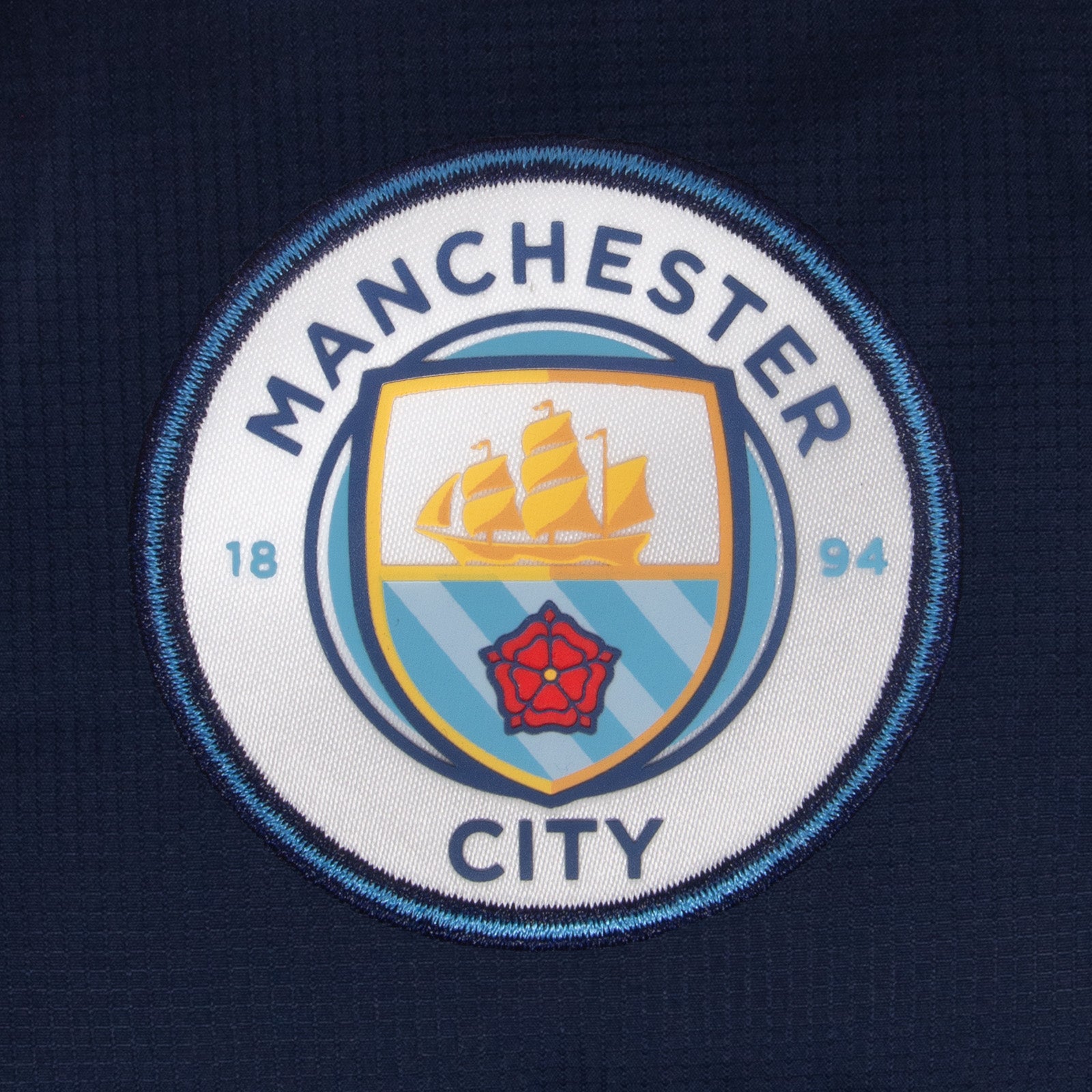 Man City kids quilted jacket in navy with club crest to chest.