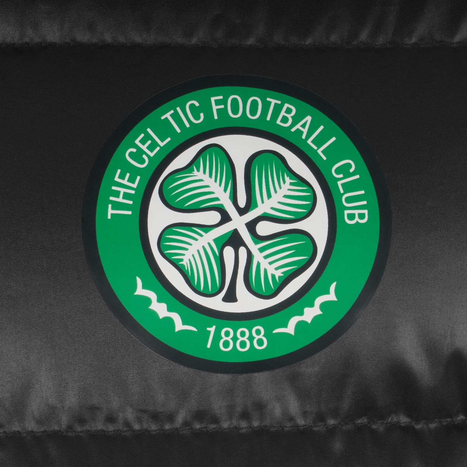 Celtic kids quilted jacket in black with club crest to the left of the chest.