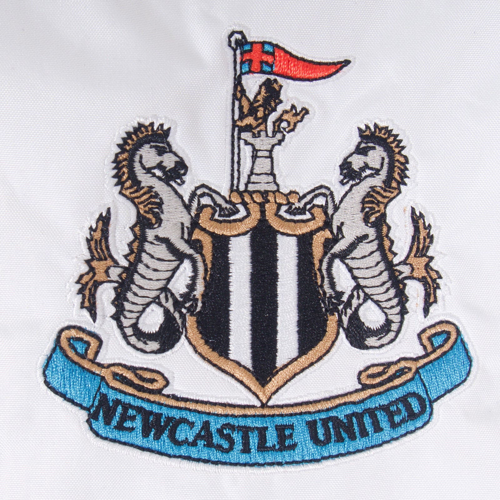 Newcastle Utdadults shower jacket in black & white with club crest to chest .
