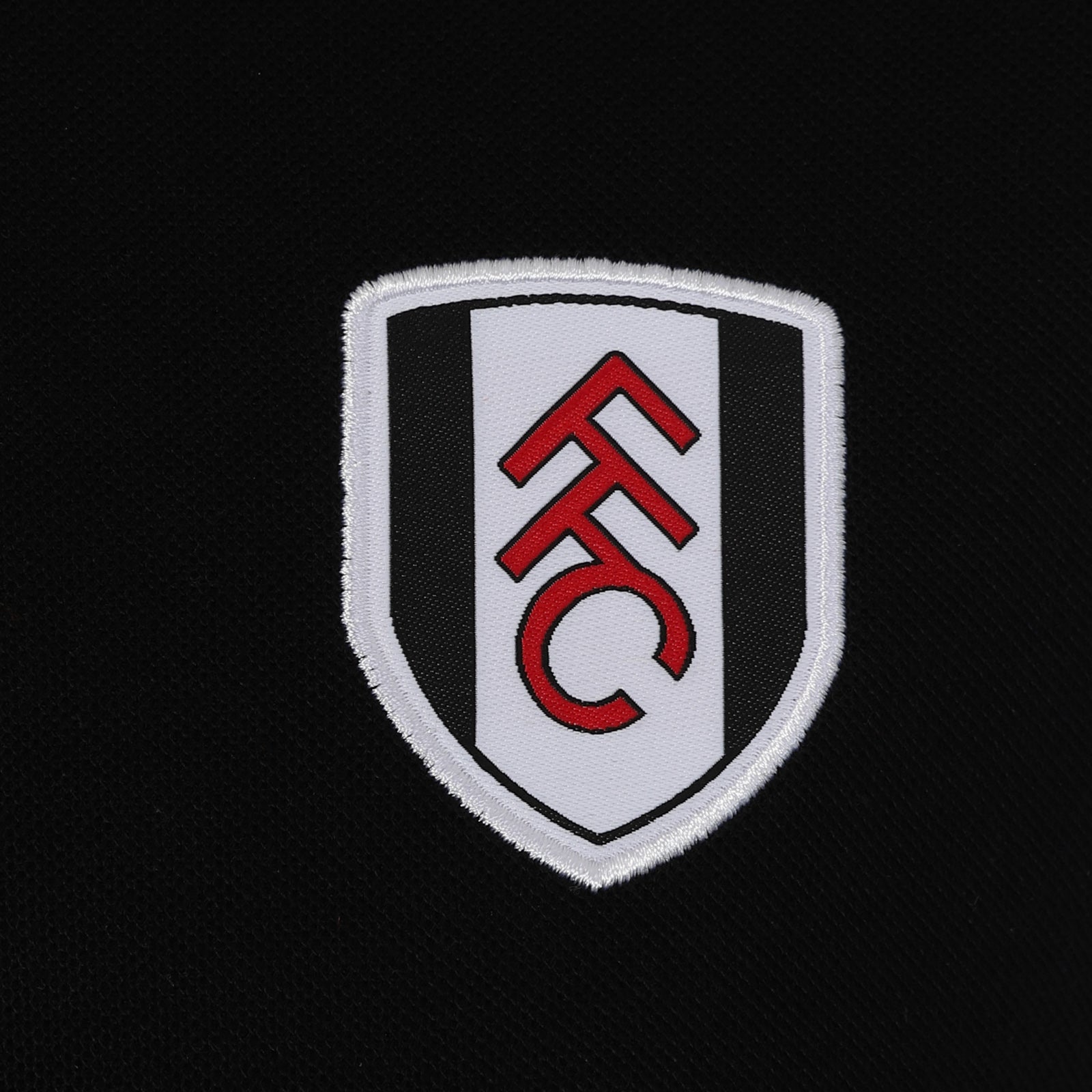 Fulham adults polo shirt in black with club badge to the chest and FFC text to sleeve