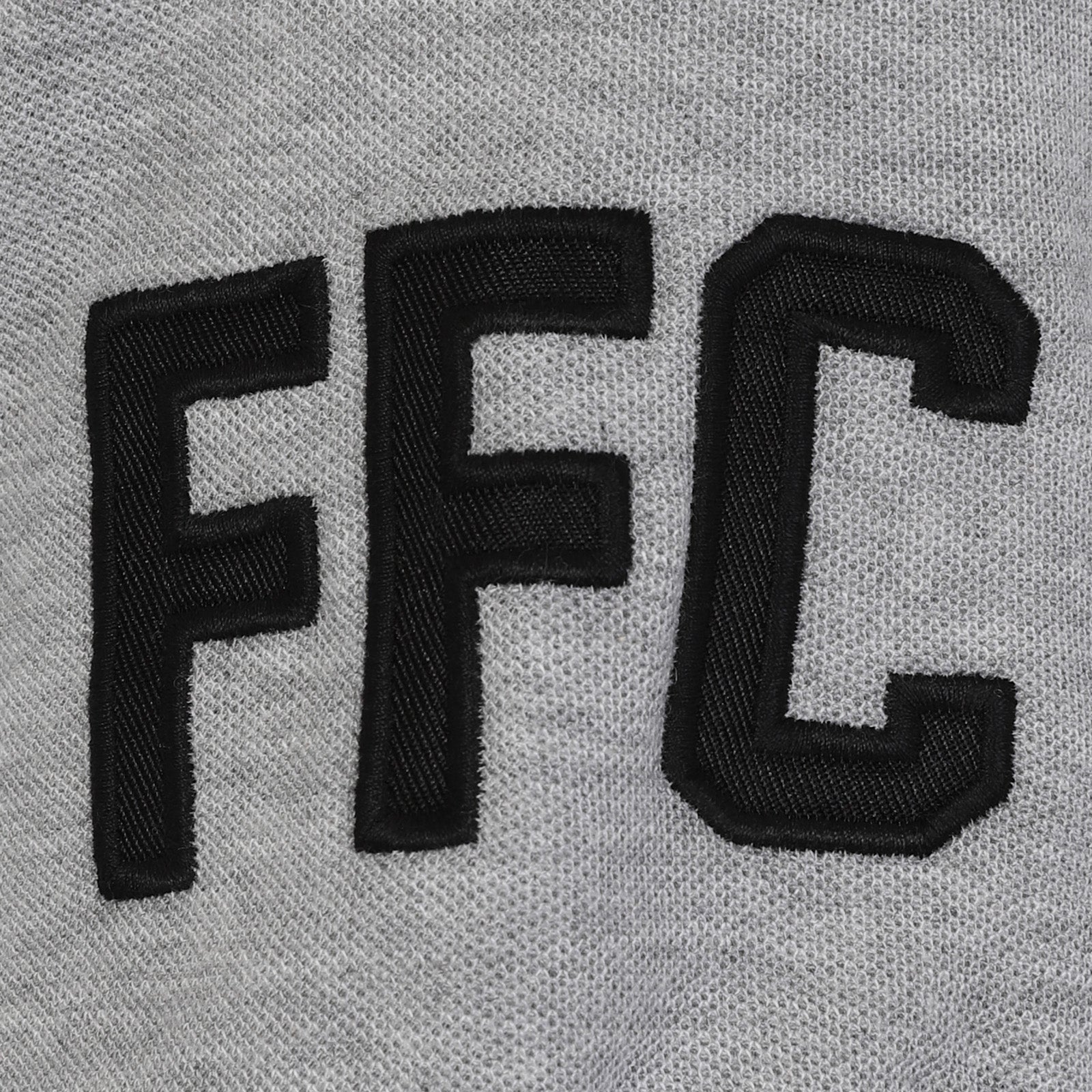 Fulham adults polo shirt in black with club badge to the chest and FFC text to sleeve