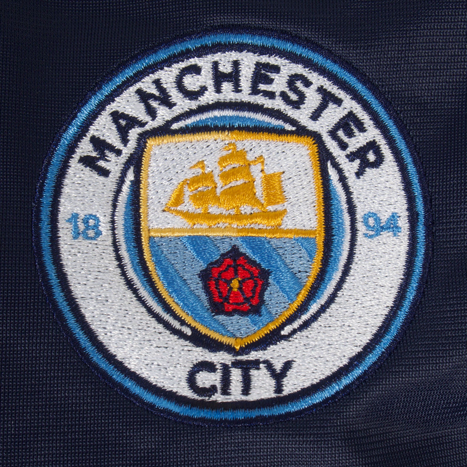 Man City adults retro track jacket in navy & sky blue with club crest to chest.