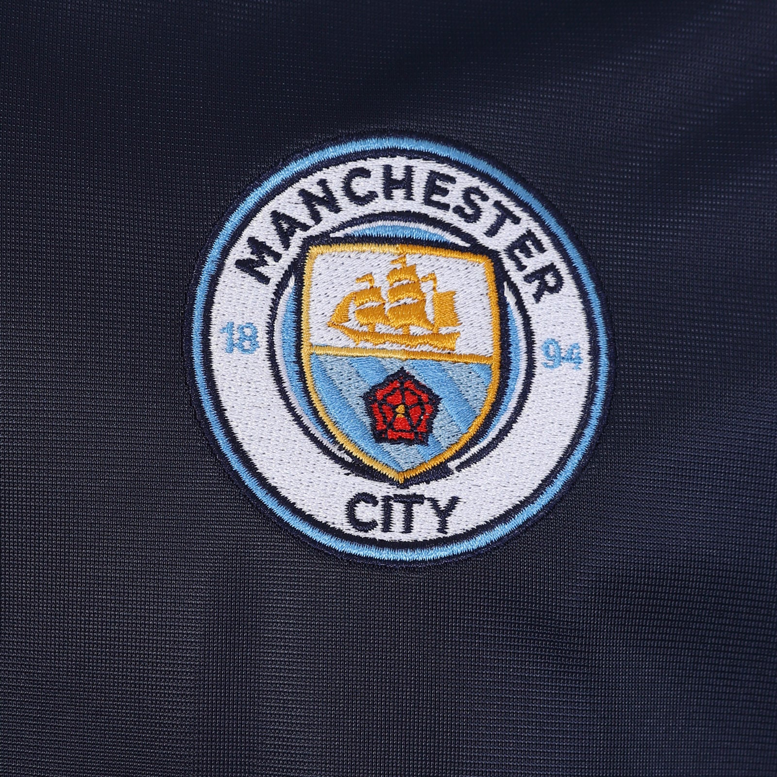 Man City adults retro track jacket in navy blue with club crest to chest.