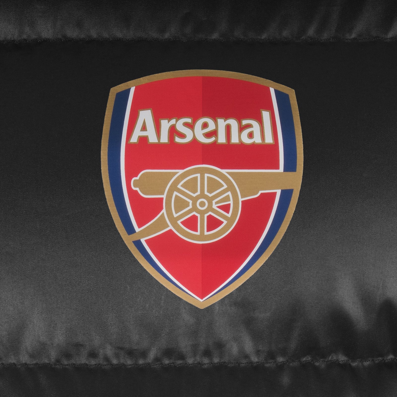 Arsenal kids quilted jacket coat in black with club crest to chest.
