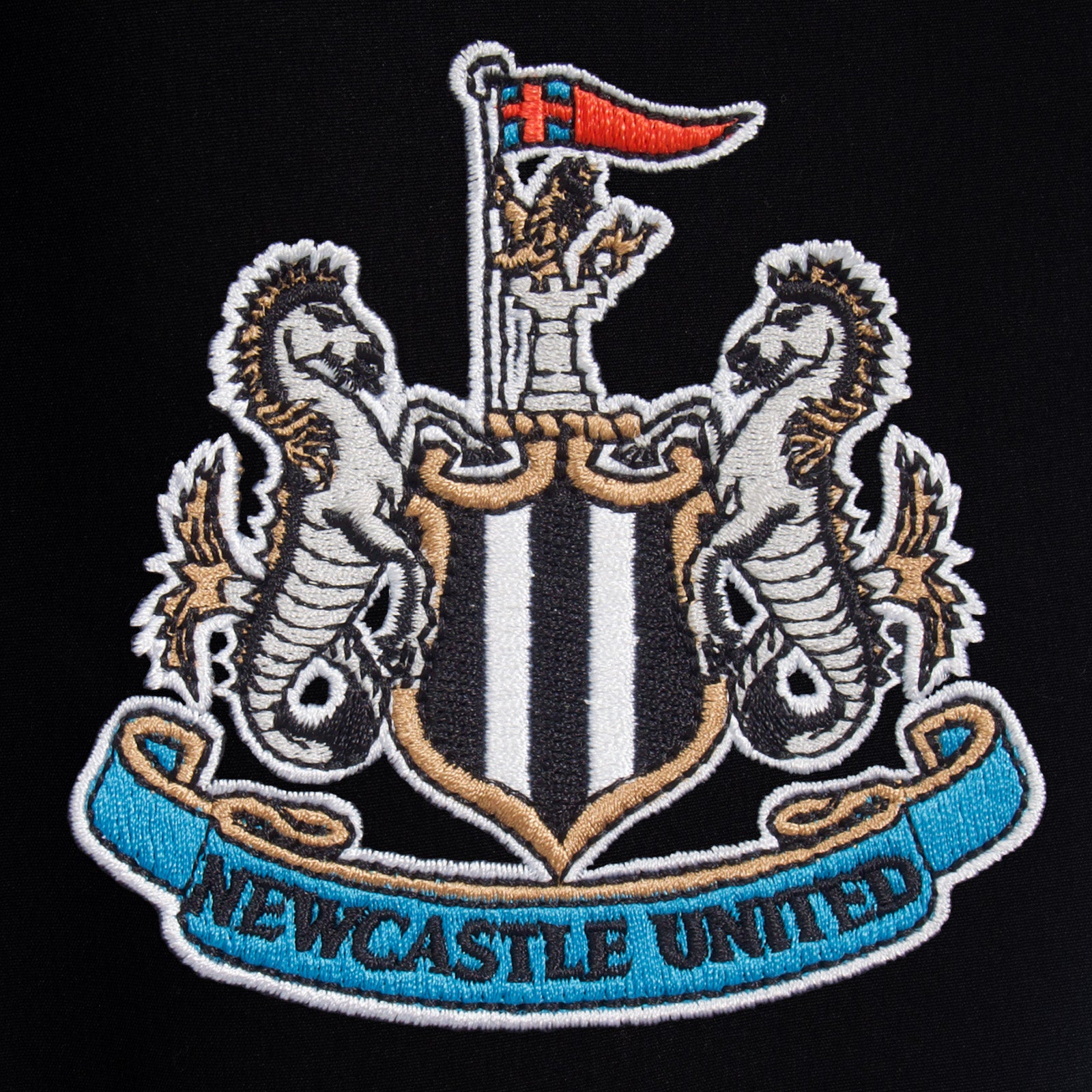 Newcastle Utd adults tracksuit in black with club crest to chest and left thigh