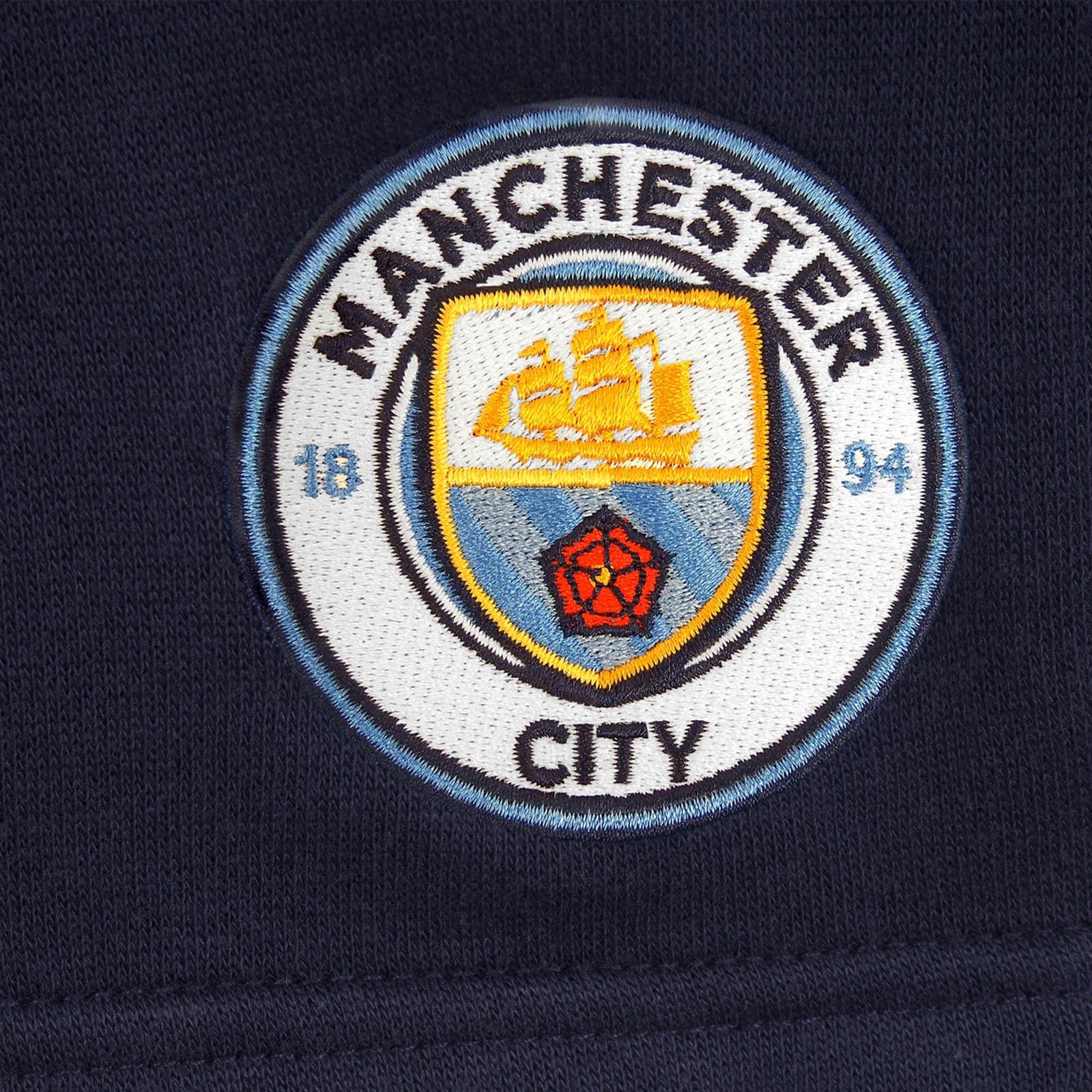 Man City adults fleece shorts in navy blue with crest to left leg and pockets to front & back.