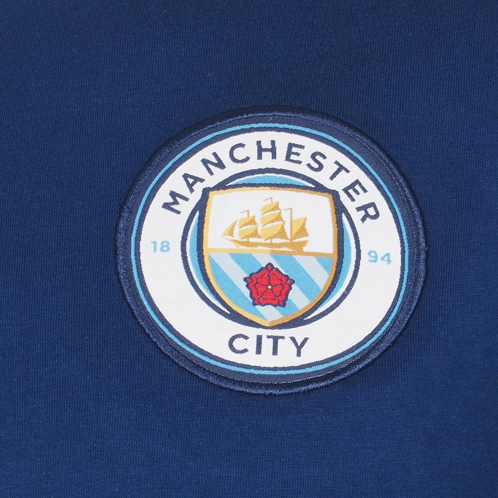 Man City adults long pyjamas in navy blue. Two-tone short sleeve top with crest and long bottoms with badge