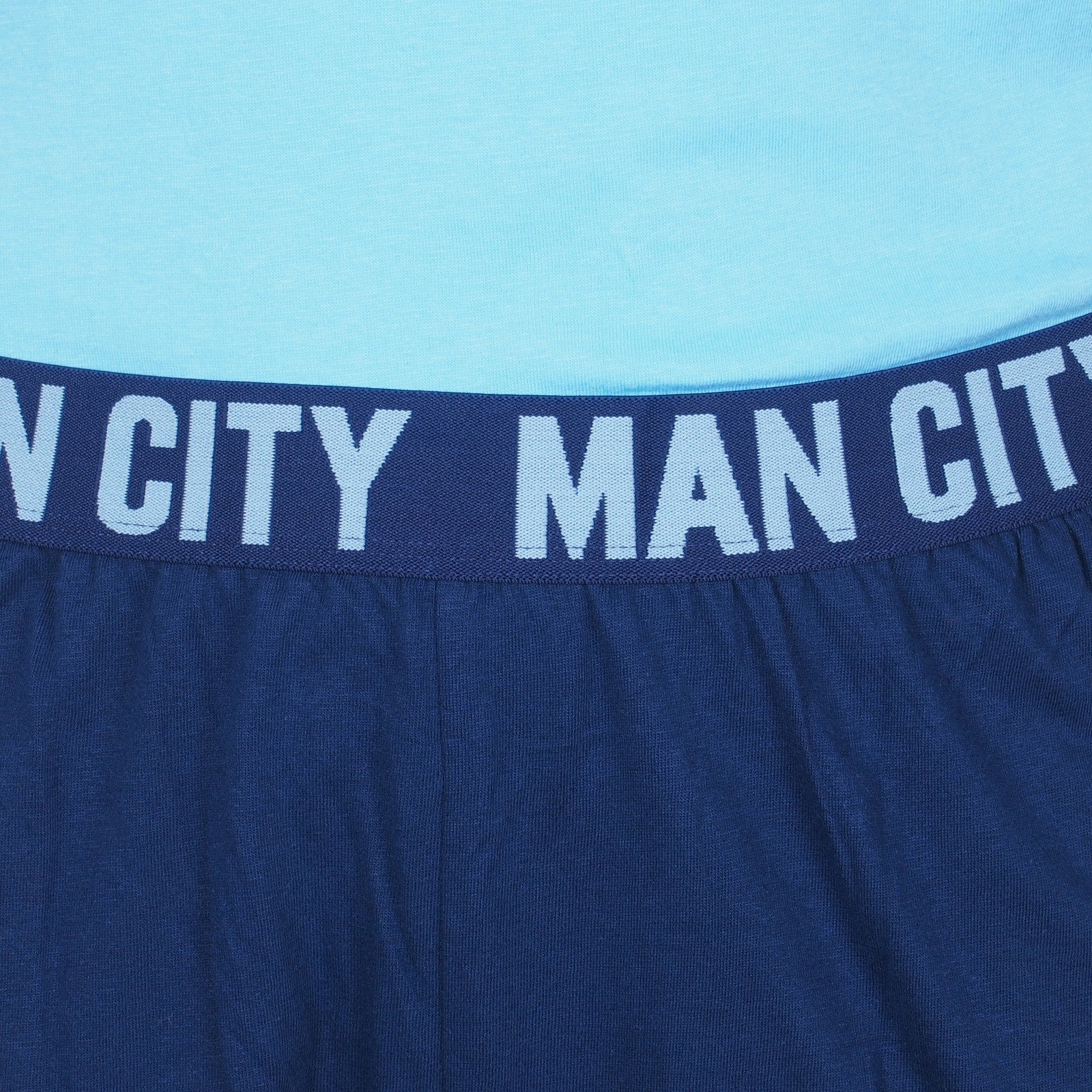 Man City adults long pyjamas in navy blue. Two-tone short sleeve top with crest and long bottoms with badge