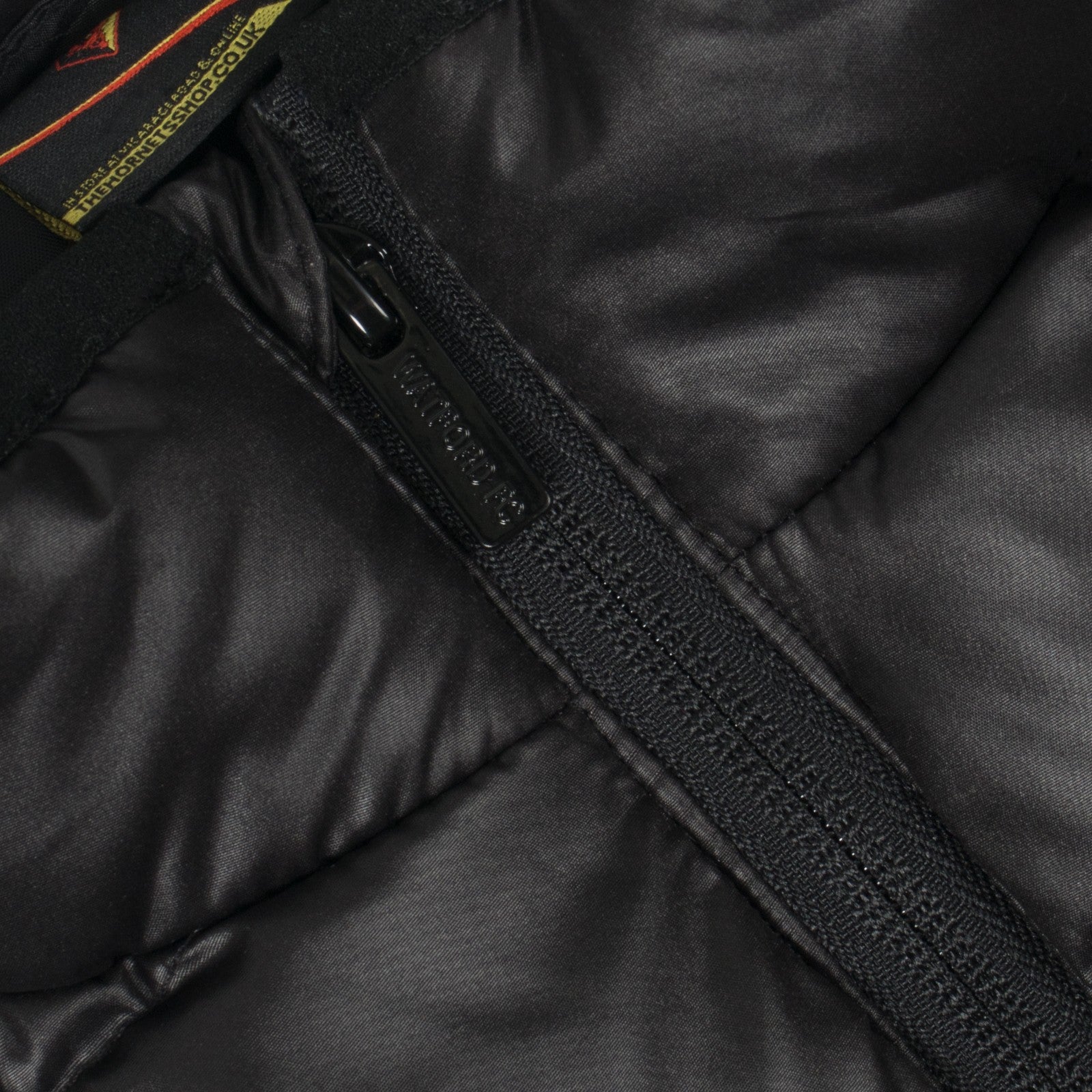 Watford adults padded gilet in black with club crest print to chest.