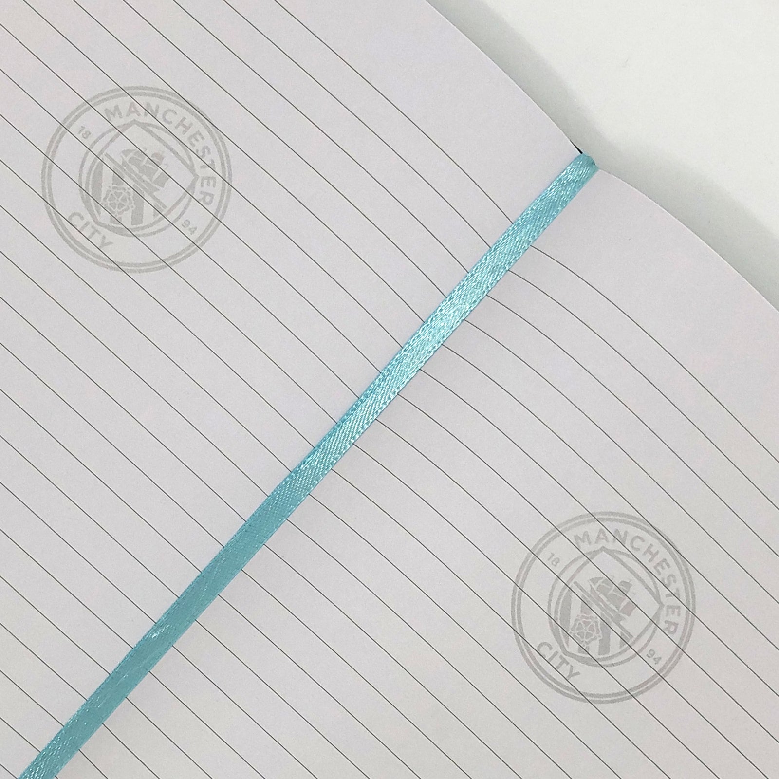 Man City notebook & pen in black with silver foil crest in club design gift box.