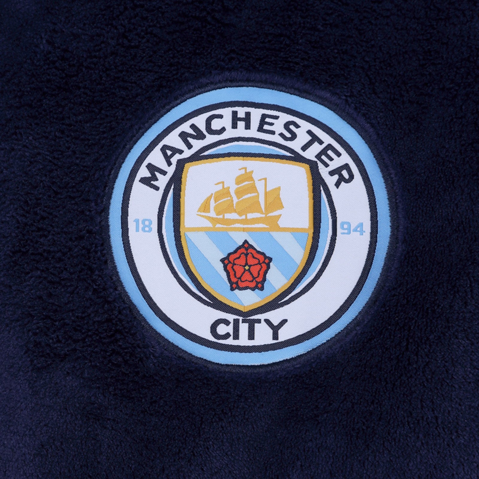 Man City baby's hooded dressing gown in navy blue with crest.