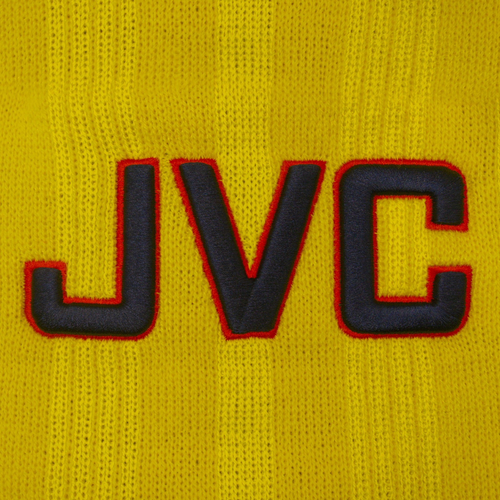 Arsenal retro knitted bobble hat in yellow with text to front